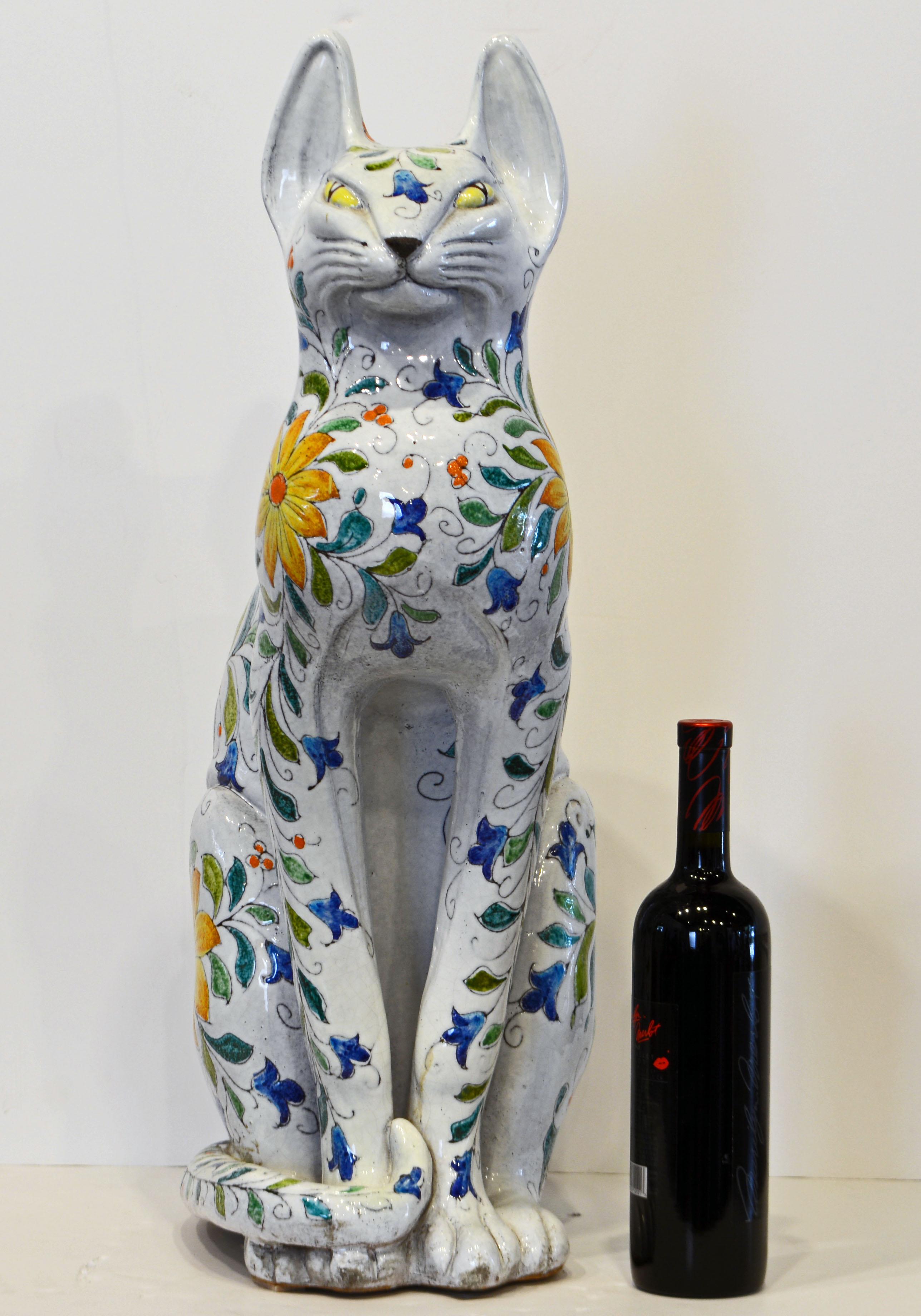 Standing 27 inches tall this Italian Egyptian inspired terracotta statue of a beautifully glazed and decorated cat is a feast for the eyes. It dates to the late 20th century and is a fine representative of the centuries old Italian majolica