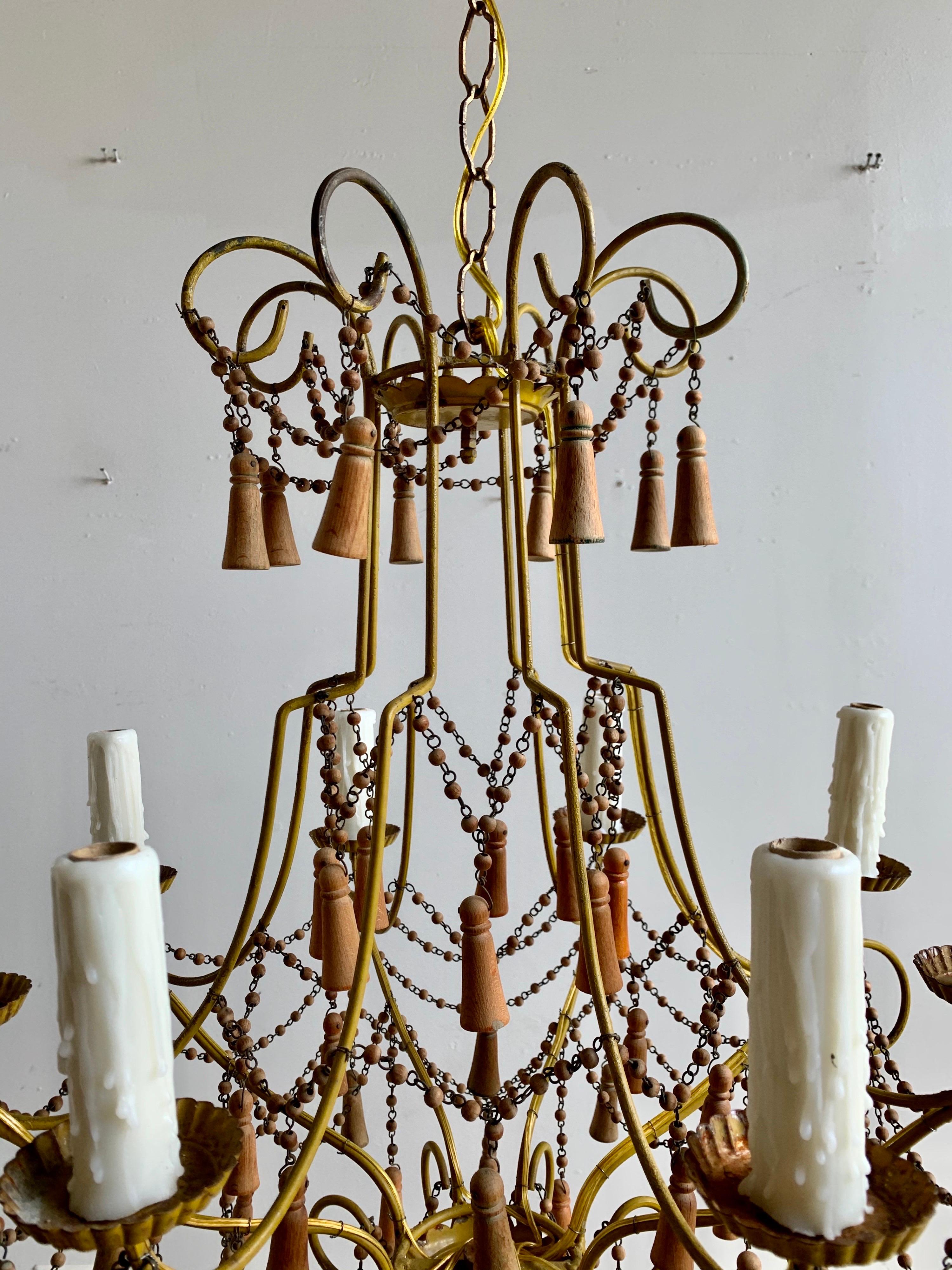 Italian eight light chandelier with wood beaded tassels throughout. The fixture is newly rewired with drip wax candle covers and includes chain and canopy.