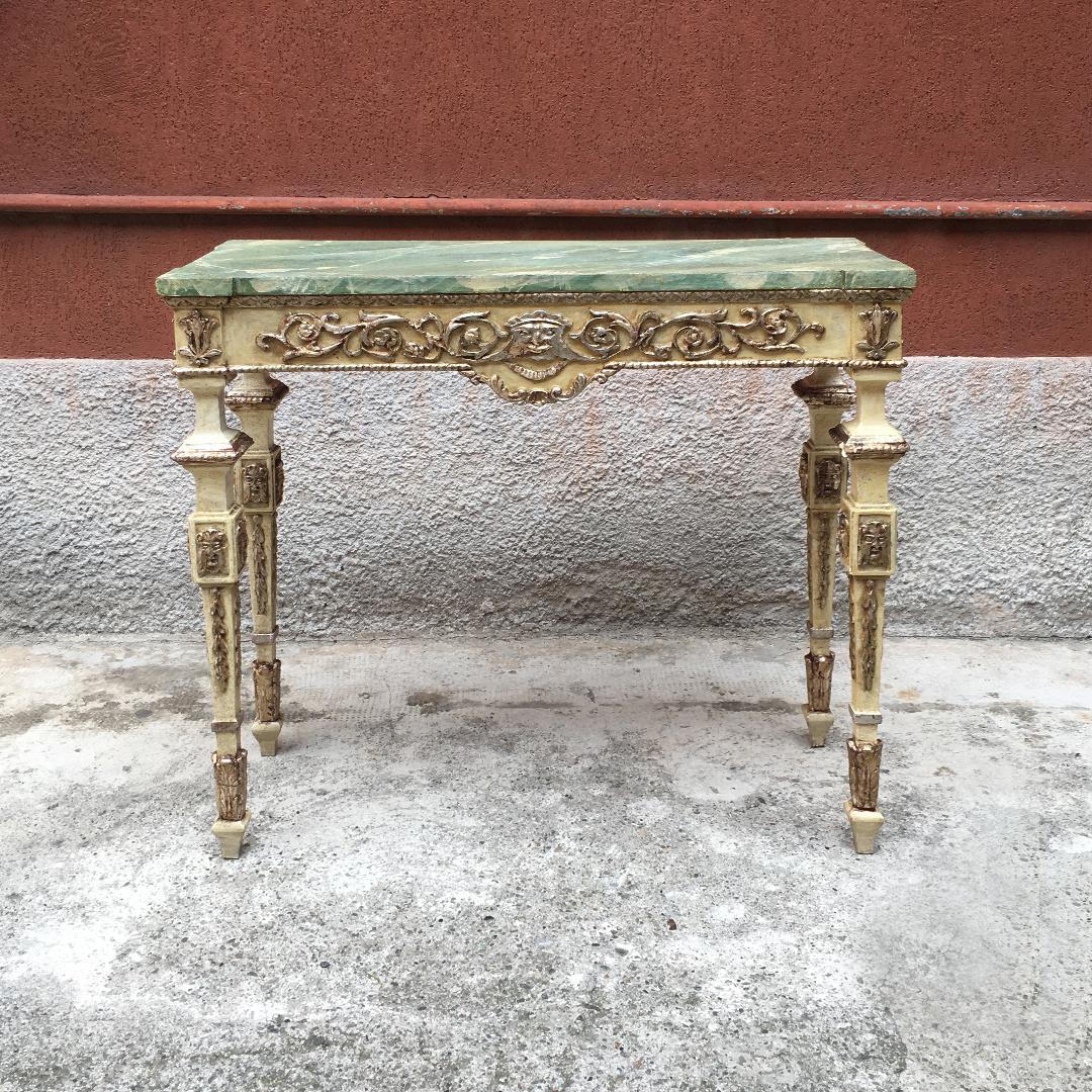Console in 18th century Venetian style, produced in the 1950s, with top in emerald green imitation marble, base in white painted wood with column legs and golden decorations on the entire structure.
Good conditions.
Measures: 98 x 38 x 91 H cm.