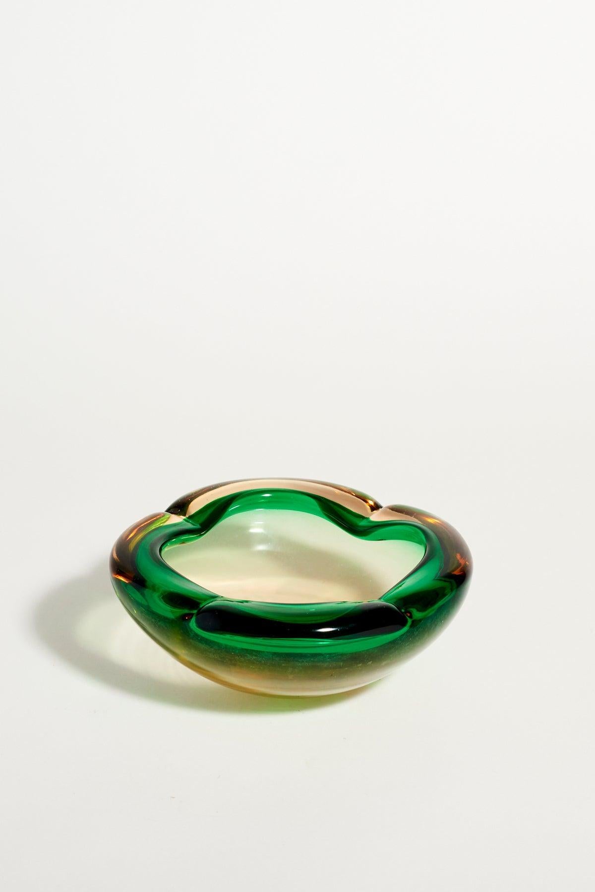 Heavy layered glass bowl with rolled edge in emerald green and amber, made in Italy.