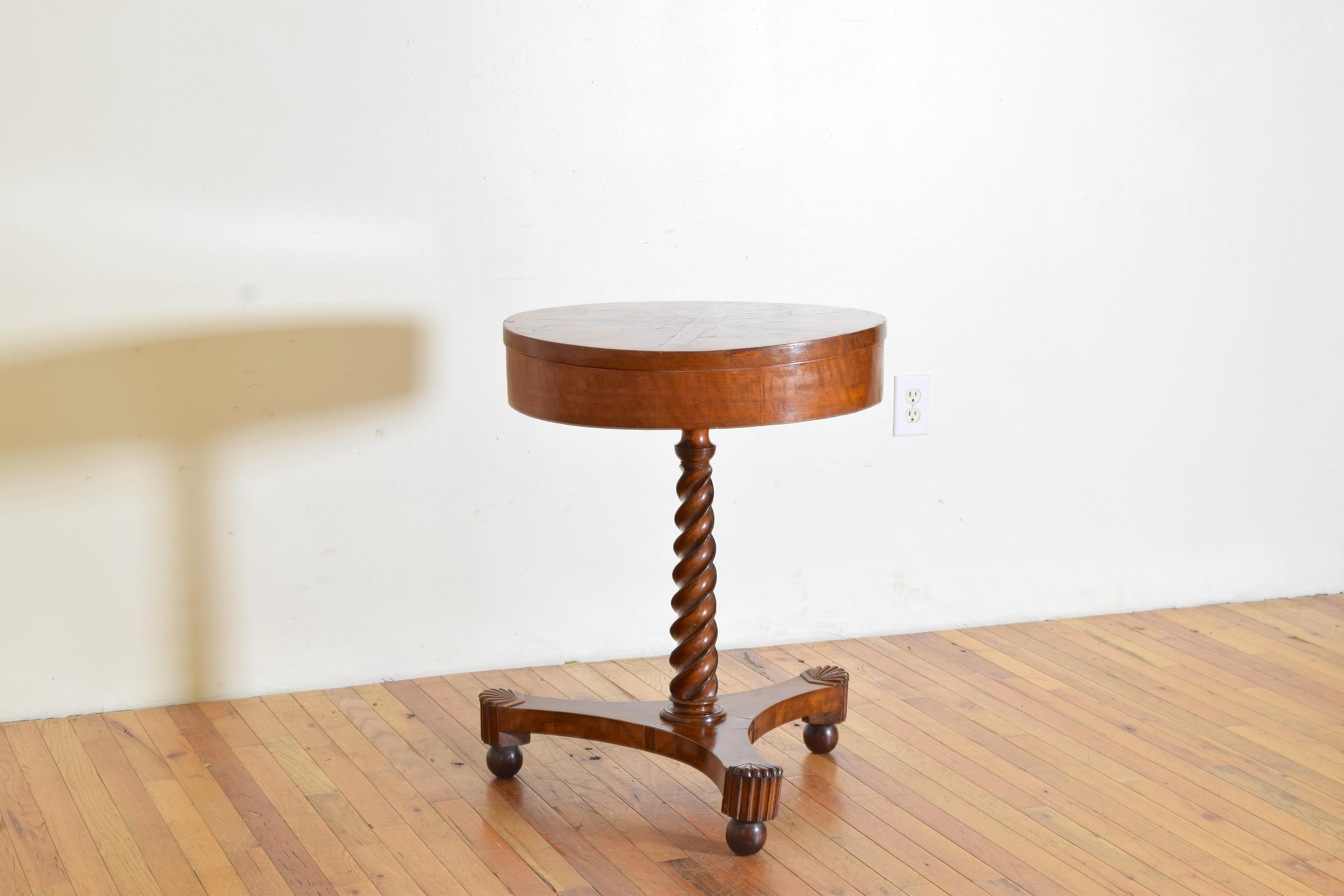 This thoughtfully crafted  table has a rotating top with an inlaid star pattern at center with wide inlays extending to the ends where they connect with half-rounds on a background of figured walnut veneers, the top twisting when unlocked by a