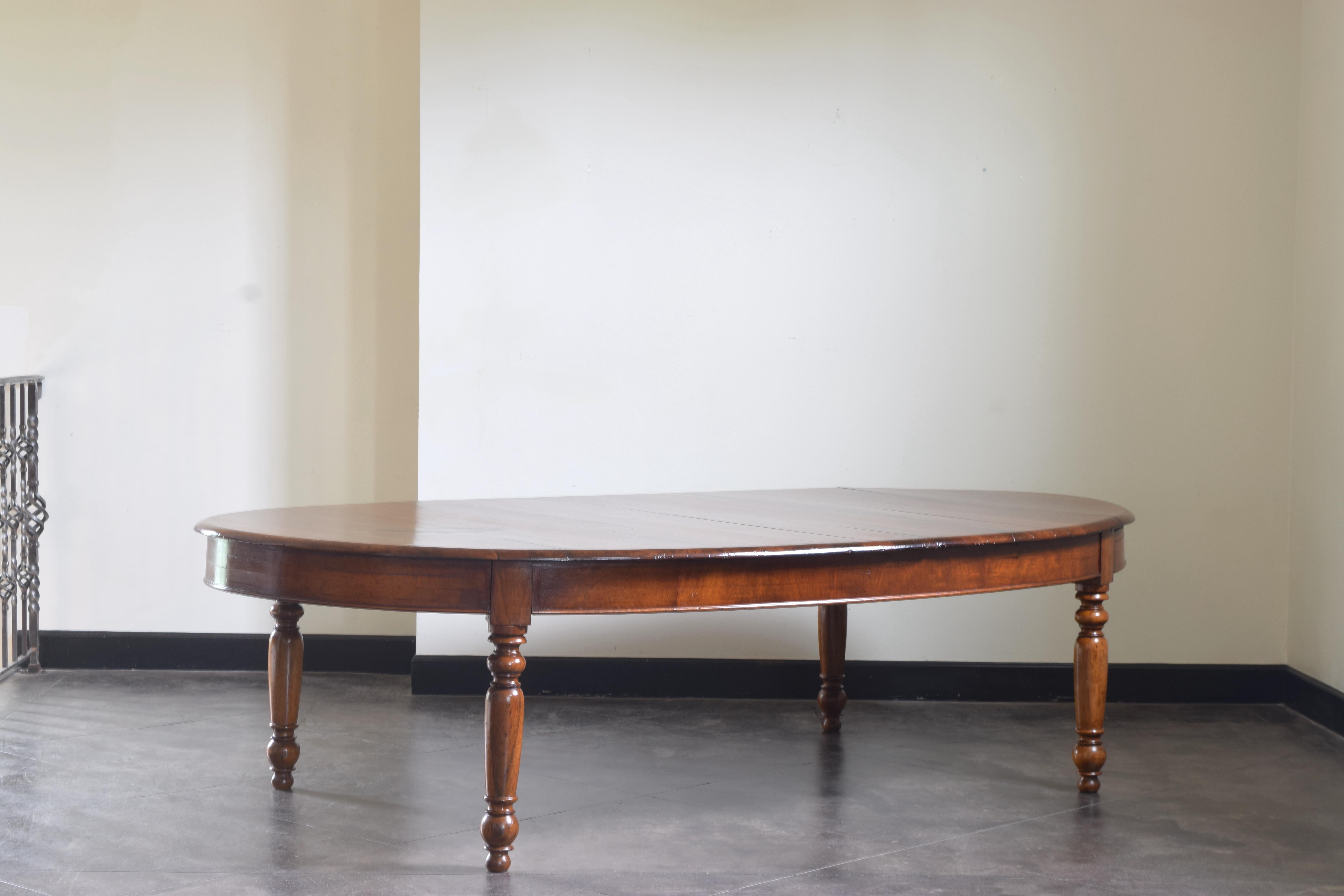 The oval top having a rounded edge atop an apron with lower molded edge, raised on removable elaborately turned and solid walnut legs, seats 8 comfortably with large chairs.
