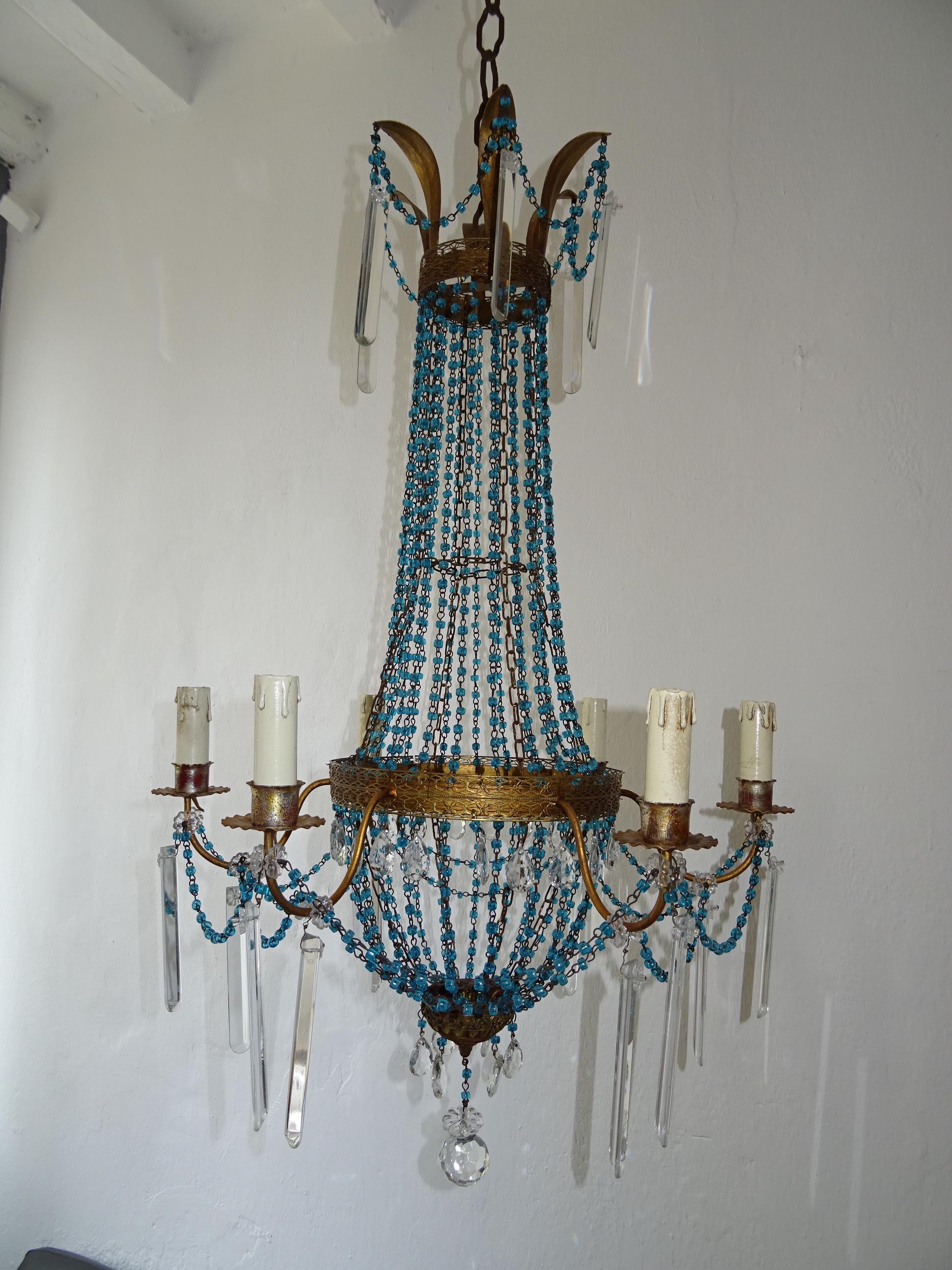 Housing 6 lights. Will be rewired with certified UL US sockets for the USA and appropriate sockets for all other countries and ready to hang. Metal body with swags of rare blue glass macaroni beads and vintage crystal prisms.  I have never seen a