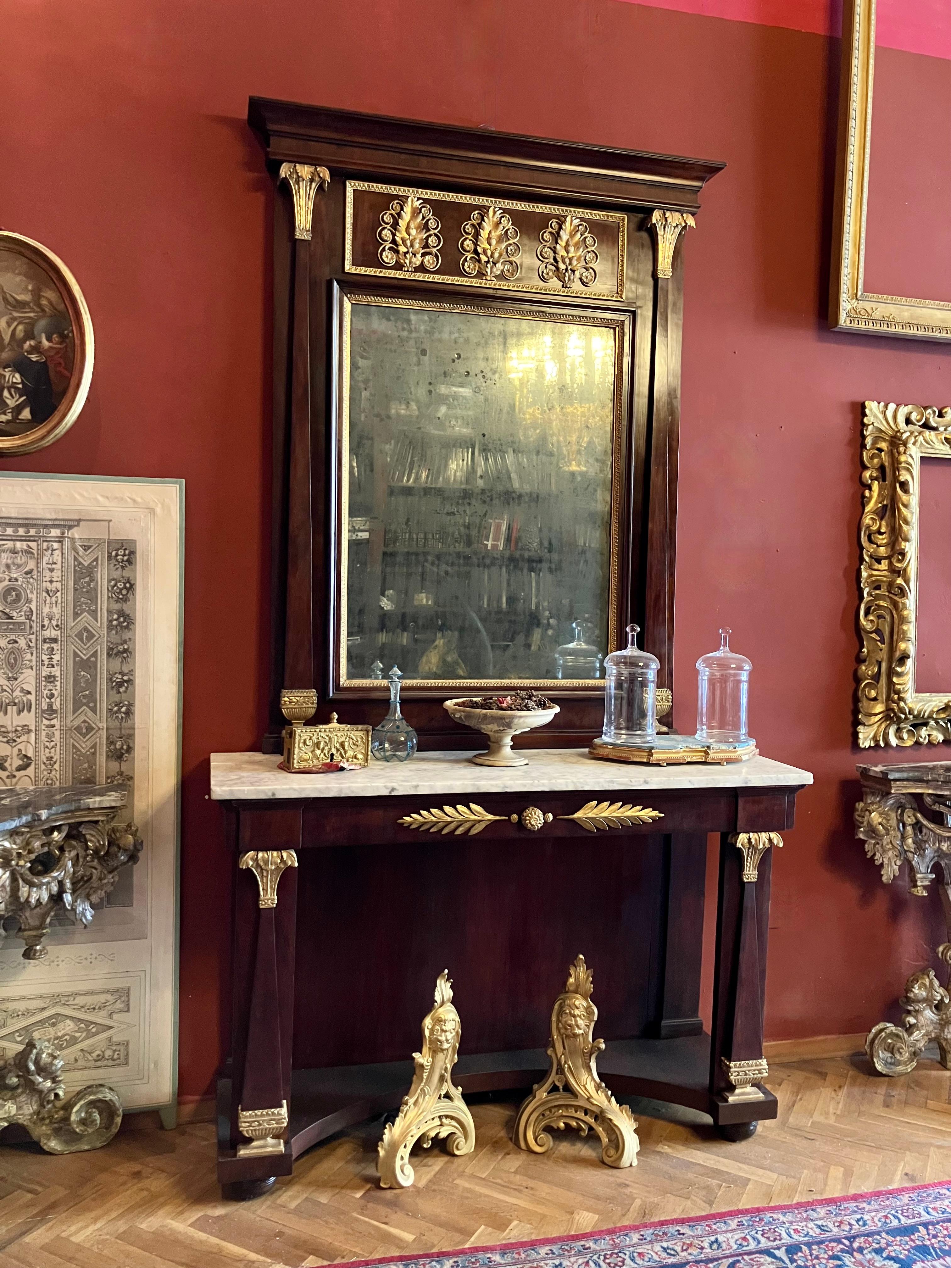 This exquisite Italian Empire period console table with mirror, dating from the late 18th to early 19th century (1790-1820), exemplifies the grandeur and refined craftsmanship of palatial furniture from this period, a work of art that has graced the