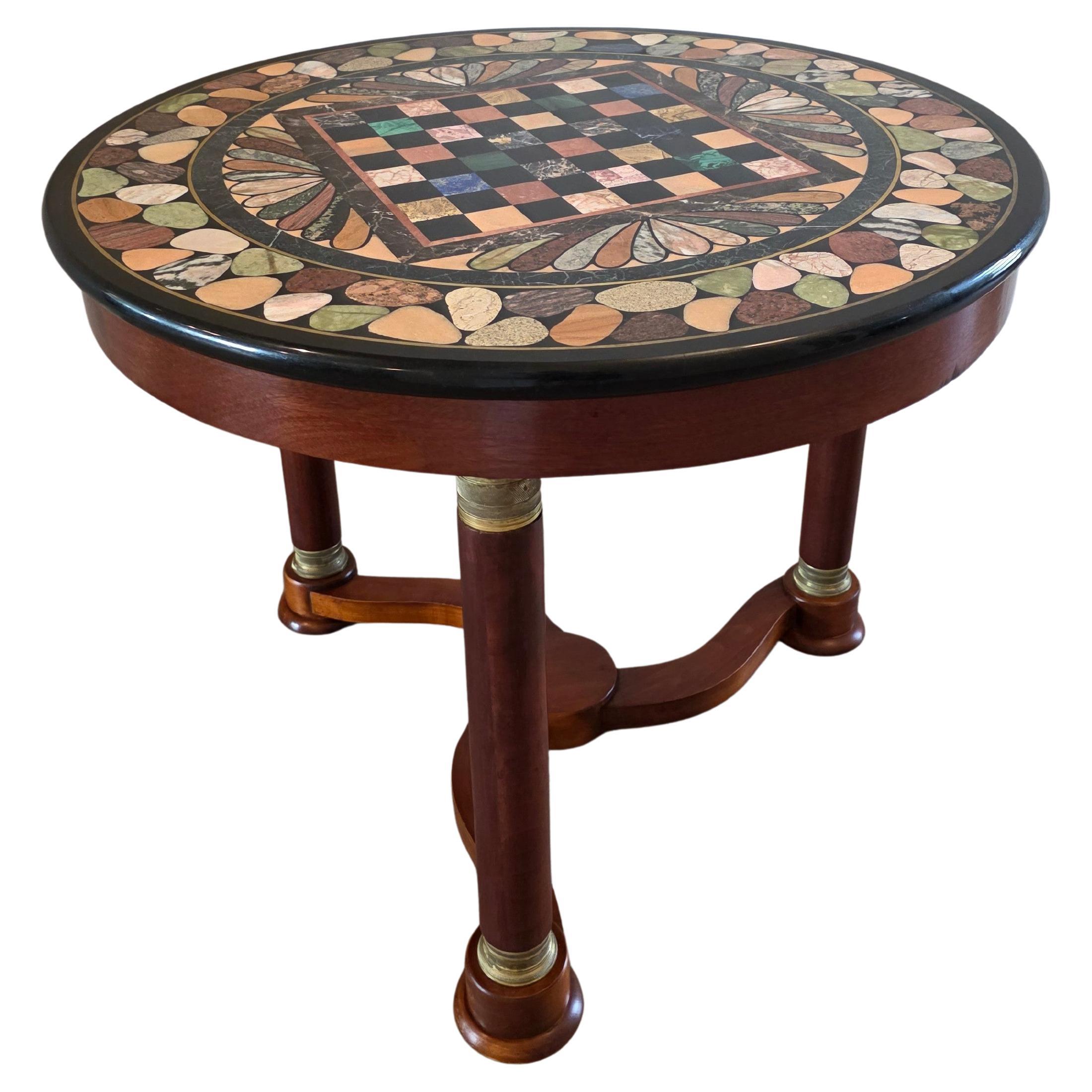 A visually striking Empire style bronze mounted mahogany guéridon centre table with spectacular round exhibition style specimen marble top with central inlaid chessboard.

Featuring a fine quality exceptionally executed Italian Grand Tour style