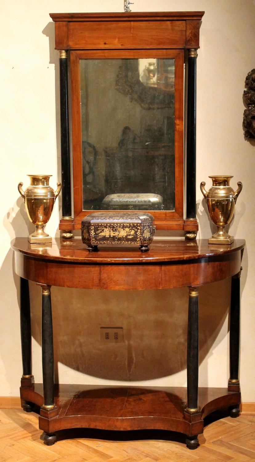 These beautiful antique Italian Empire demilune console tables with mirrors date back to early 19th Century. We can assume they were made in Florence, Italy and they come from a villa in the Tuscan countryside. 
These are a very good quality console
