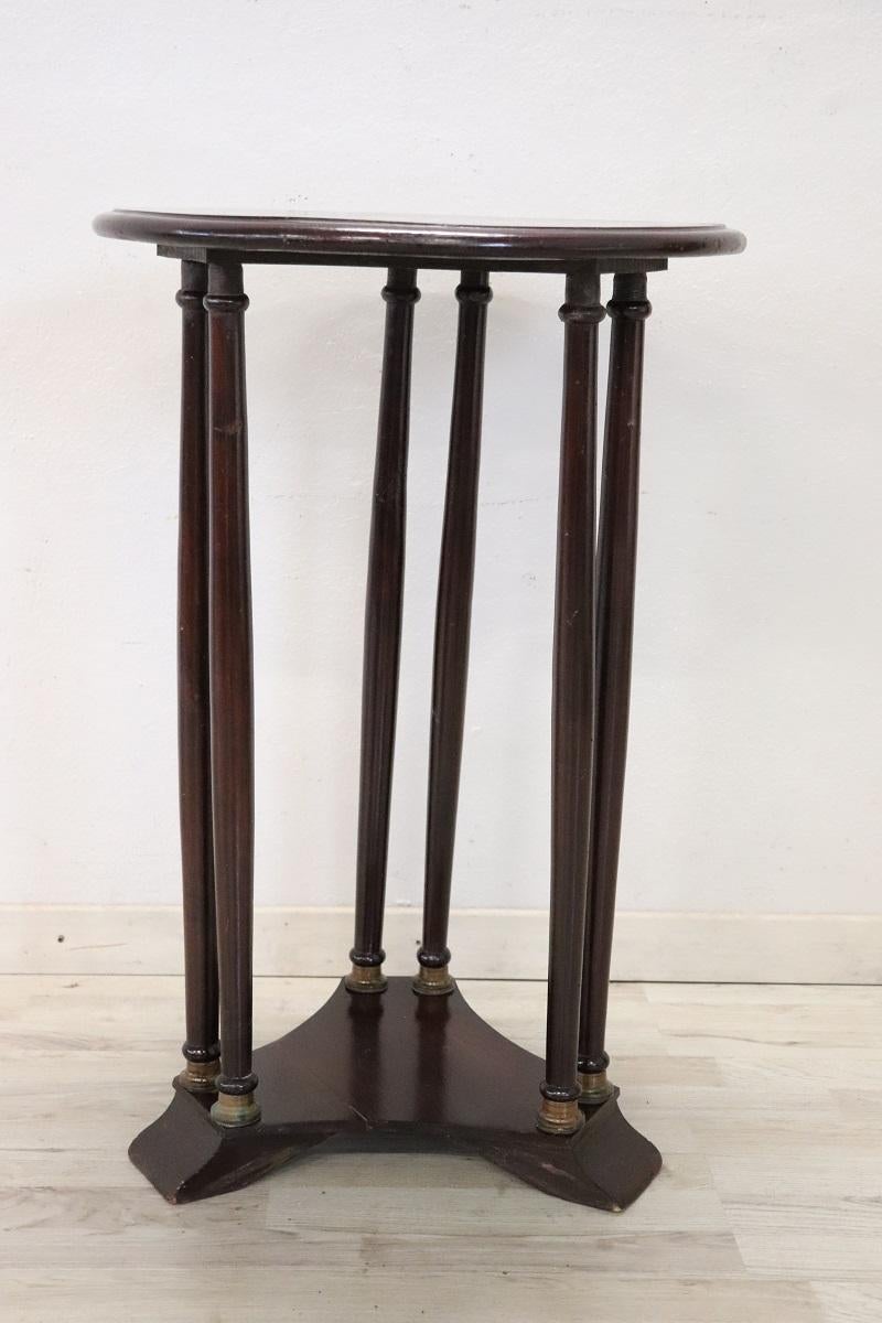 Rare and fine quality Italian empire style round pedestal table in beech wood. The top is supported by three pairs of refined columns. In the lower part the columns end with a delightful bronze decoration. Perfect for supporting a vase or decorative