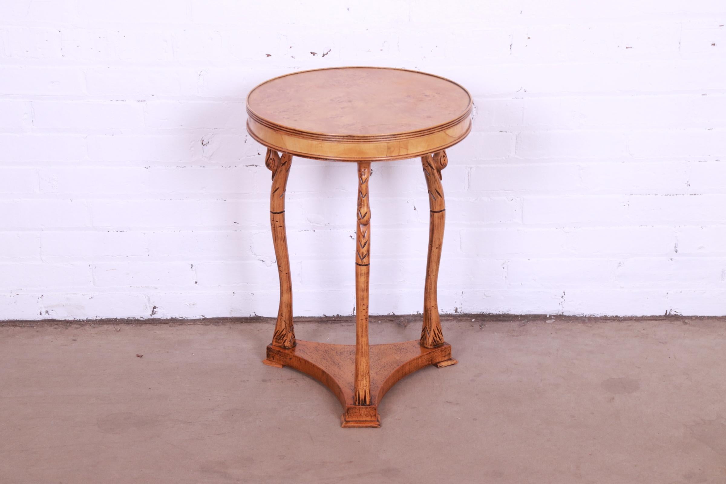 A gorgeous Empire style occasional side table or tea table

Italy, 20th century

Carved maple base in swan motif, with burl wood top.

Measures: 16