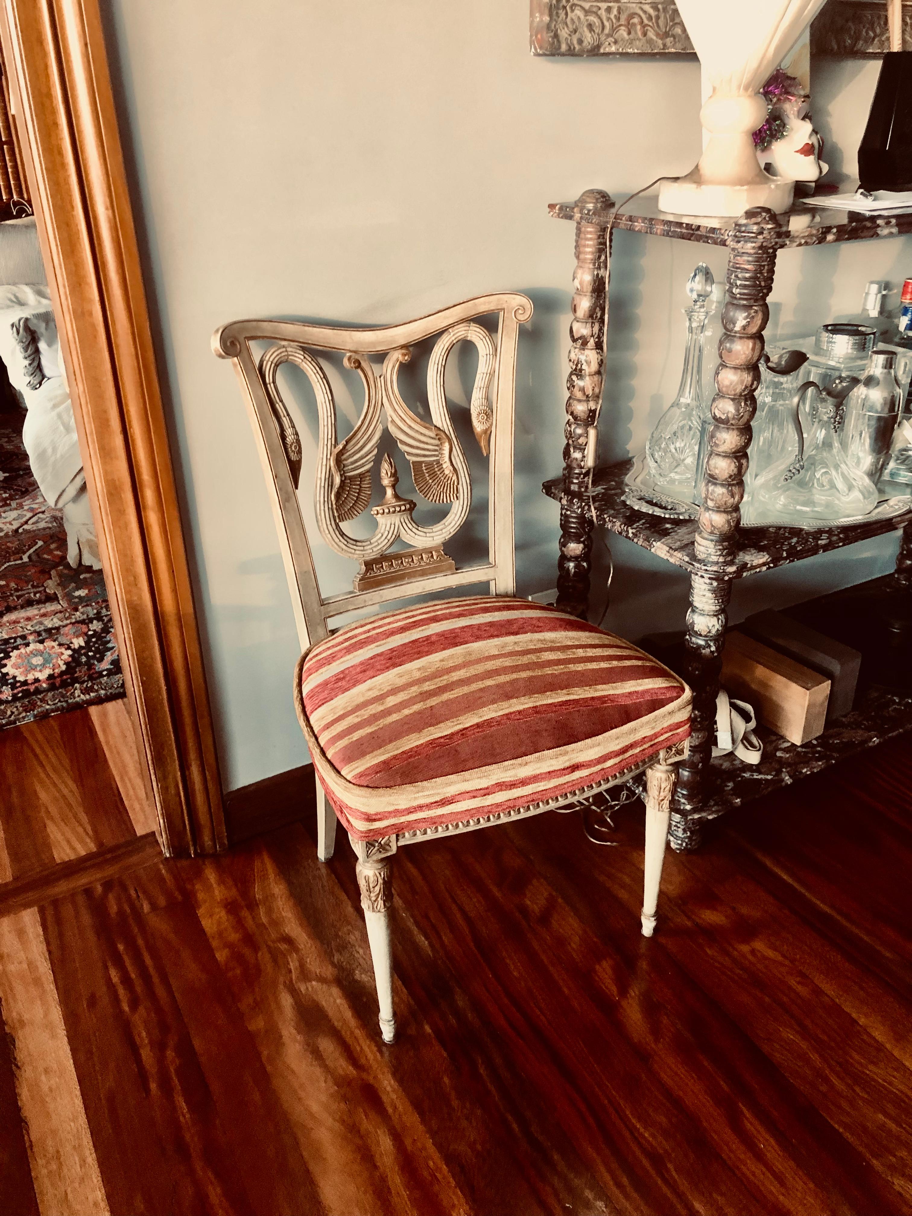 Neoclassical Revival  Italian  19th chairs.
A very nice and decorative Chair model with a pair of beautiful swans at back of the chair.
Nicely cut decor around the chair seat & reeded legs.
The chairs is upholstered in a classic stripe velvet