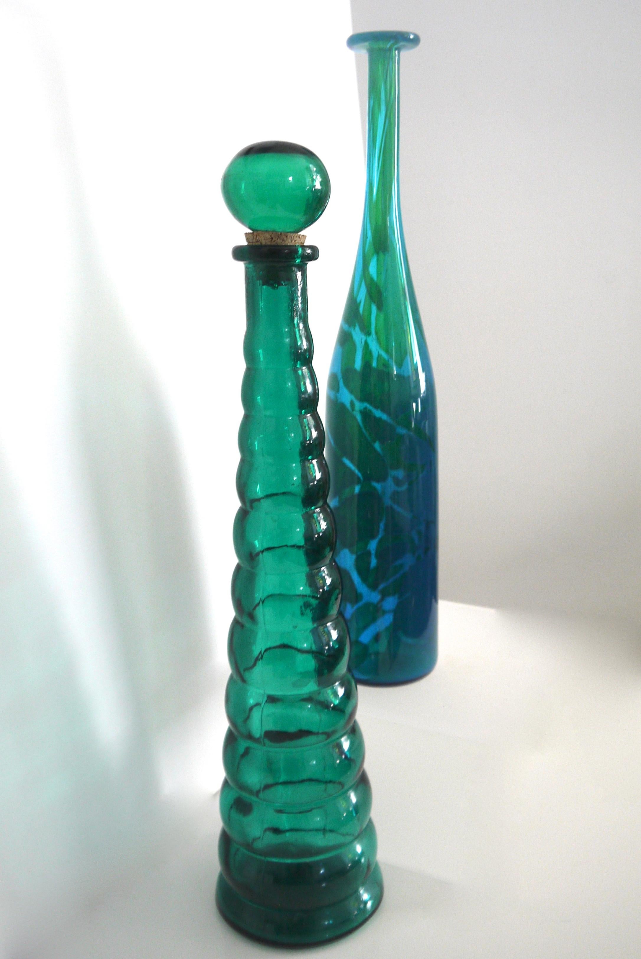 Italian Empoli moulded glass bottle from late 1950s with Mdina freeform sculpture Michael Harris early 1960s
Michael Harris sculpture was made during his time in Malta heavily inspired by the Mediterranean Sea.

The moulded bottle is from the