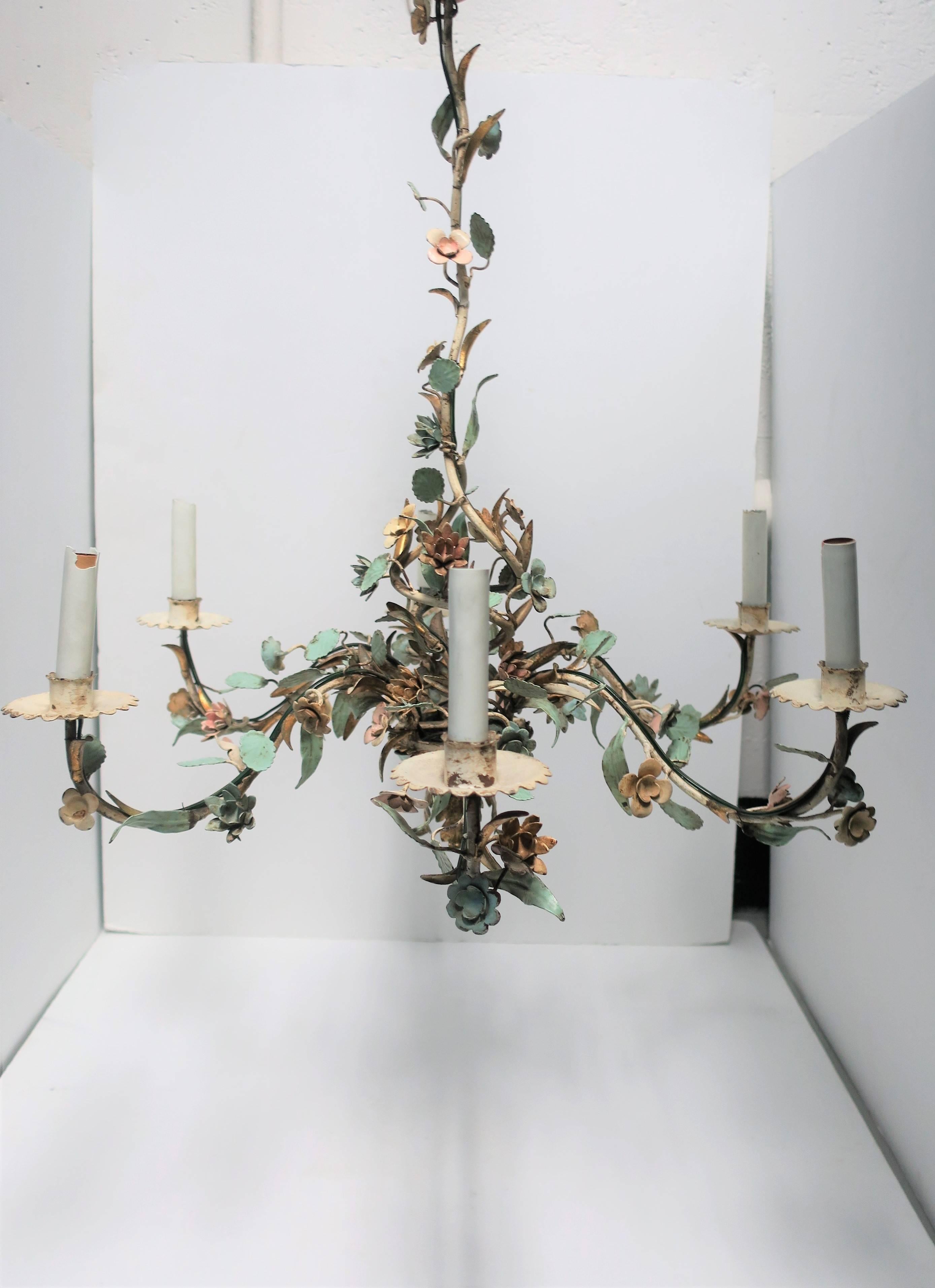 Bring the outside in with this beautiful Italian enamel and gold gilt tole chandelier with six lights, Italy, circa 1940s. Chandelier depicts a beautiful wild flower garden comprised of small detailed enameled flowers and leaves in pink,