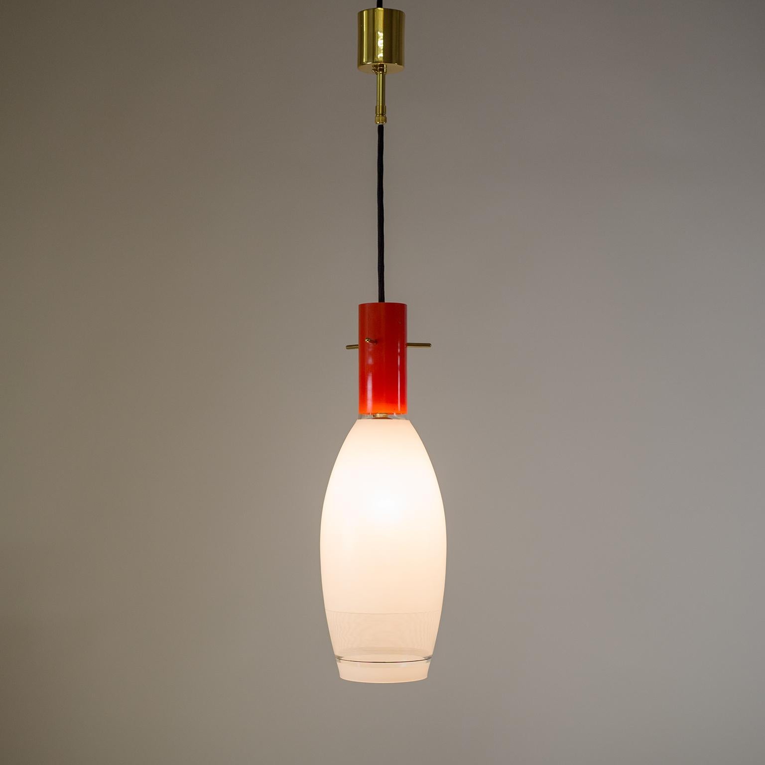 Italian glass pendant with brass details, circa 1960. The blown glass body is enameled in solid red and white, with black and white pinstripe decor on the lower half. Brass parts have been repolished and varnished. One original brass and ceramic E27