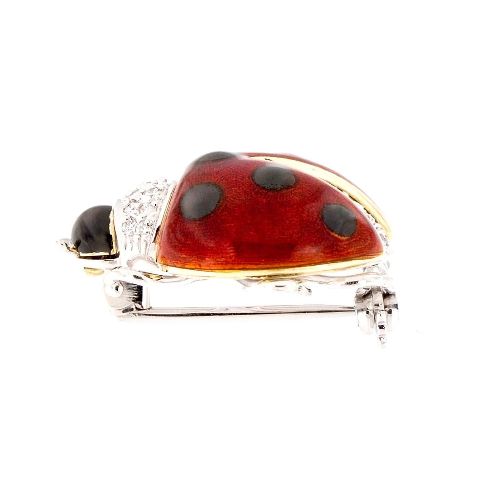 Adorable enamel ladybug brooch made in Italy is constructed of 18k yellow and white gold, accented with diamonds. Weighs 9.6 grams

Diamonds 0.19 cttw