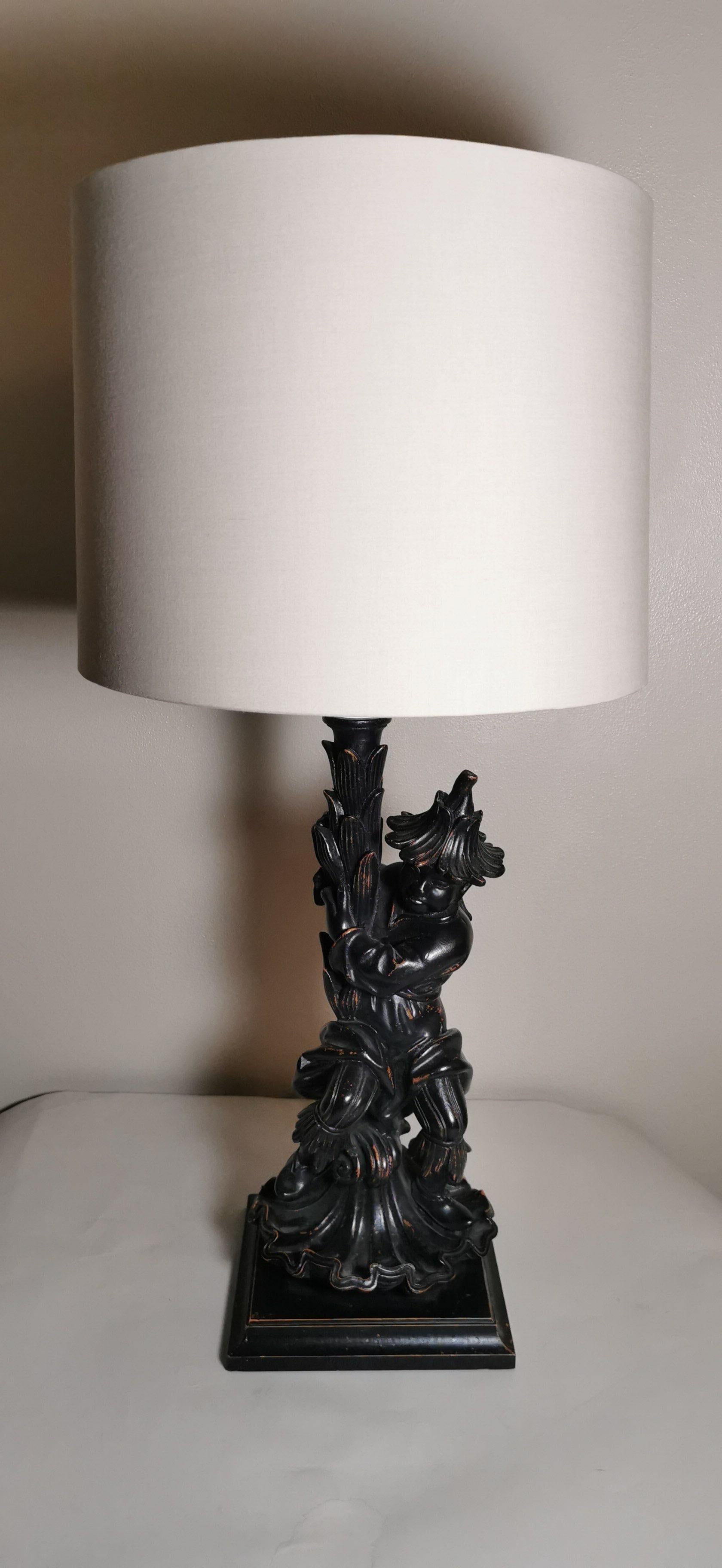 Elegant and exotic engraved and antiqued wood lamp portraying an oriental character. 
This lamp is part of a set of two.

This lamp comes without the lampshade.

Artecornici design produces hand colored art prints, artisan frames, lightings,