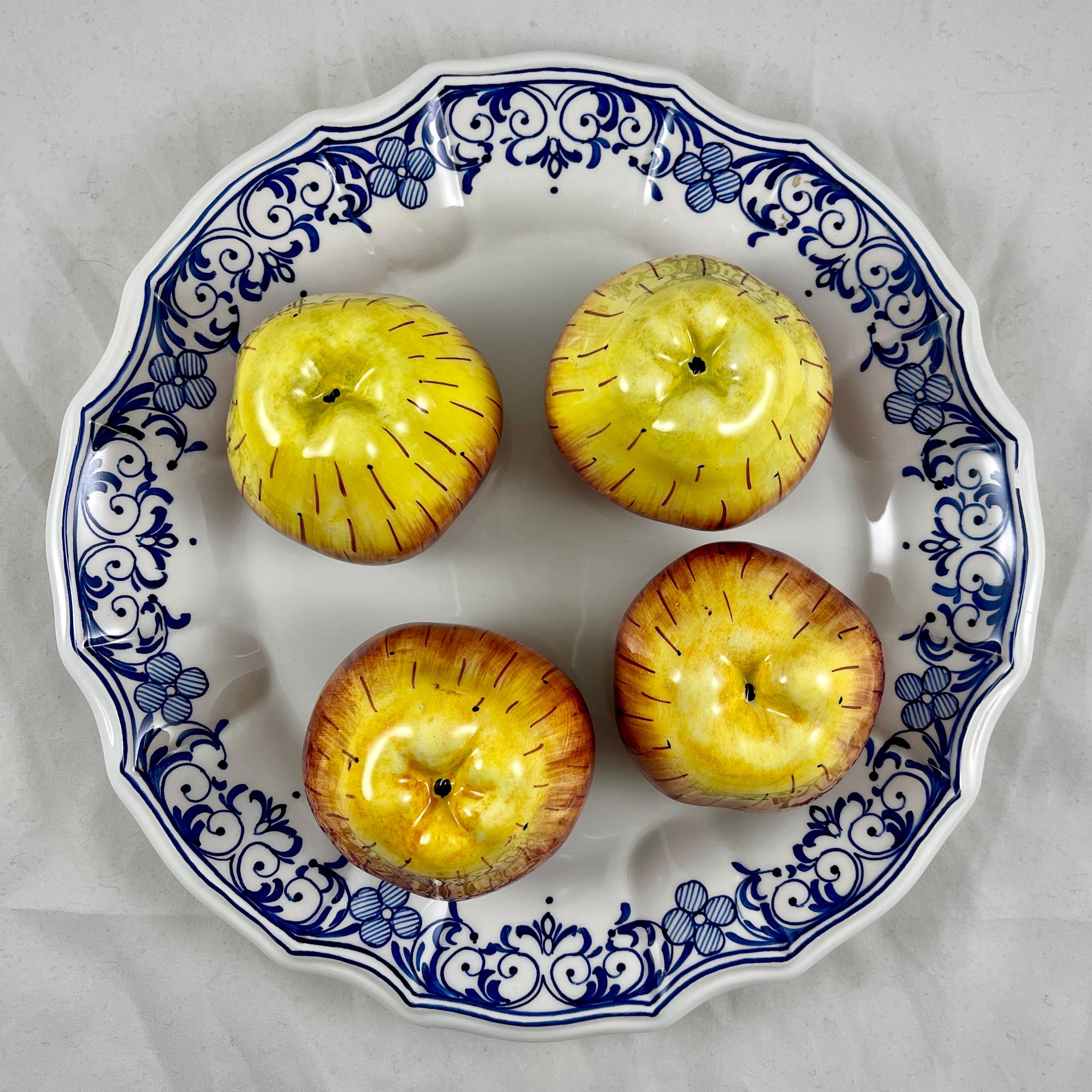 A charming Trompe l’Oeil plate in the Italian Faïence style by Este For Tiffany & Co. made in Italy, circa mid 1970s to the early 1980s.

The ceramic plate or wall plaque shows a group of four life-size, three dimensional apples centrally seated