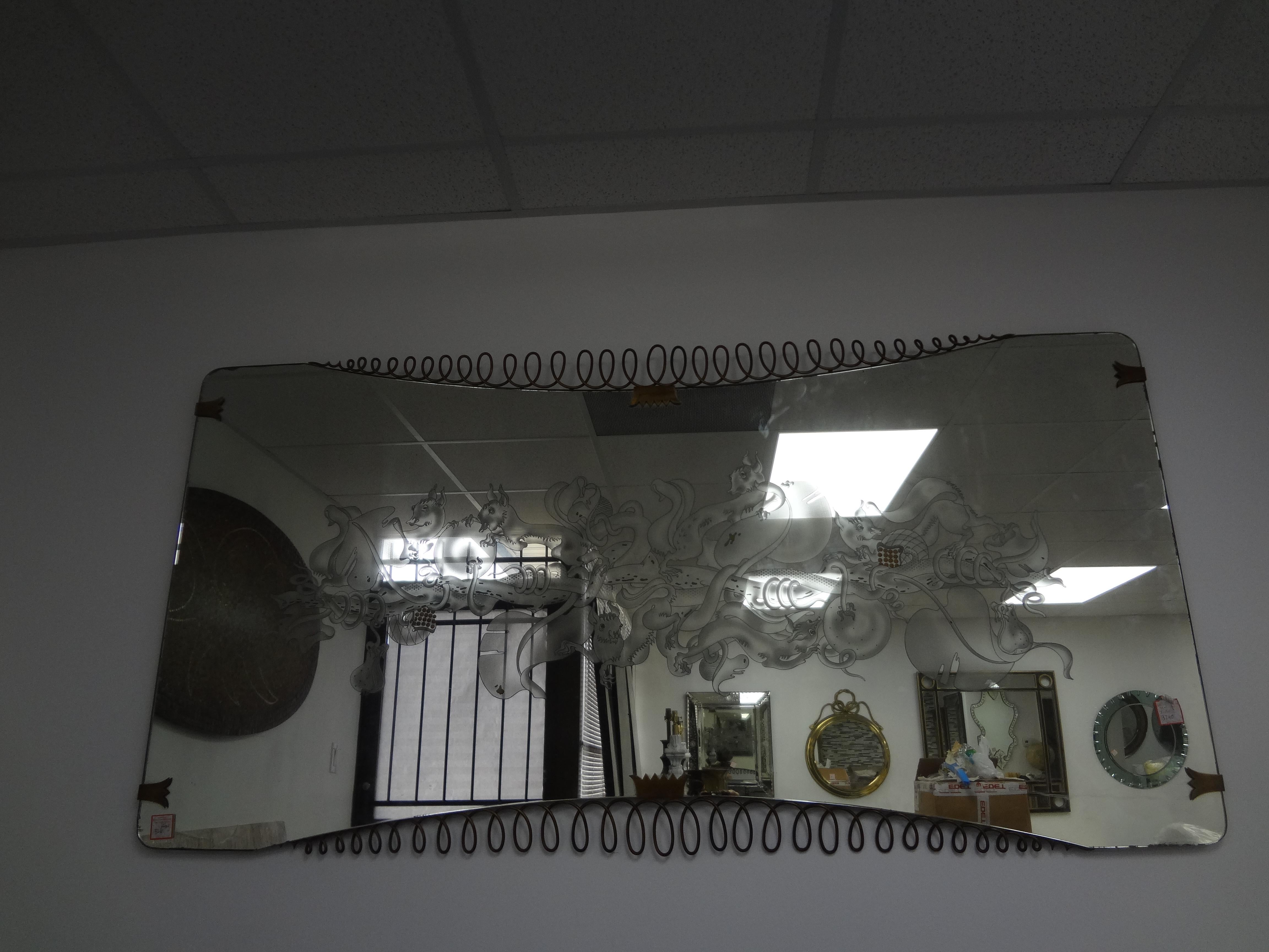 Italian Etched Mirror With Brass Accents Att. To Max Ingrand For Fontana Arte.
This magnificent large Italian mid century modern horizontal mirror has a beautiful etched dragon design trimmed with brass accents.
A most unusual statement mirror!
