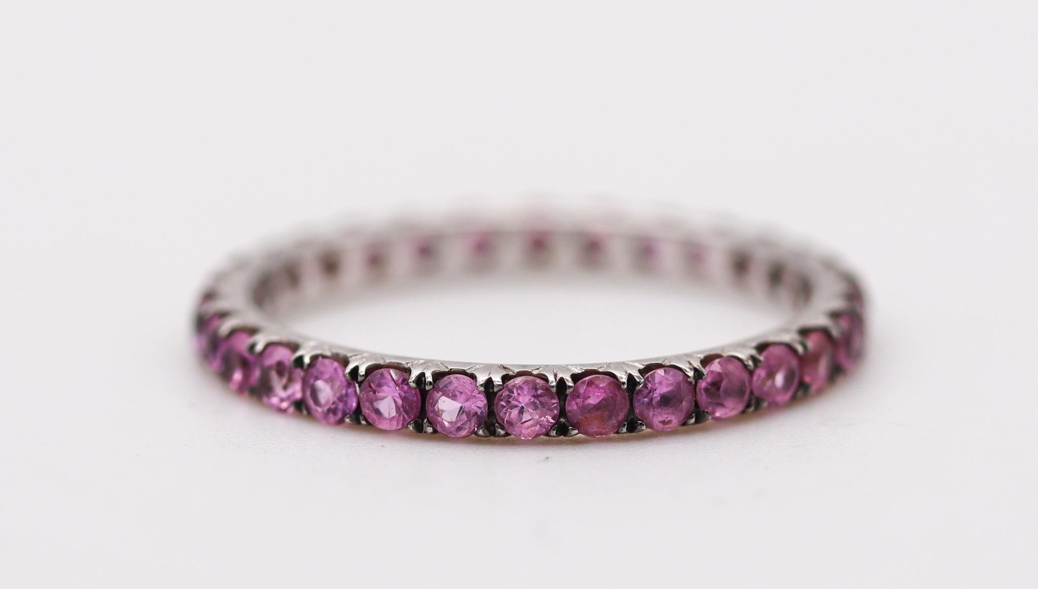 Eternity band with pink sapphires.

Beautiful eternity ring band, crafted in Italy in solid white gold of 18 karats with high polished finish. Mounted with a great selection of thirty calibrated pink sapphires with accents of black