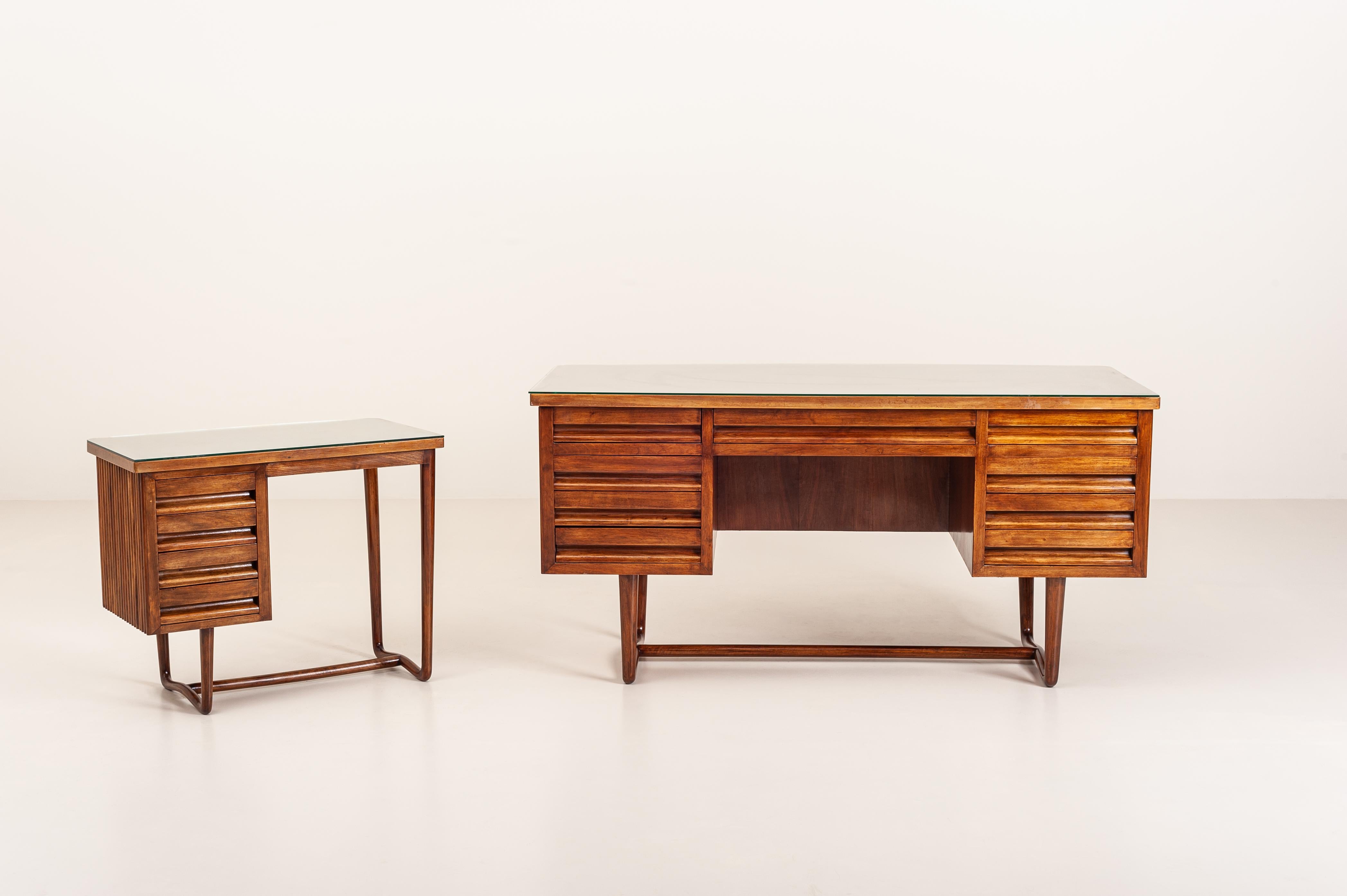 Unique and exceptional Italian executive desk made in solid walnut covered with a glass top. This table were produced in the 1950s.

Craftsmanship of this piece is at an exceptional level: solid walnut has been carved on the surface with a