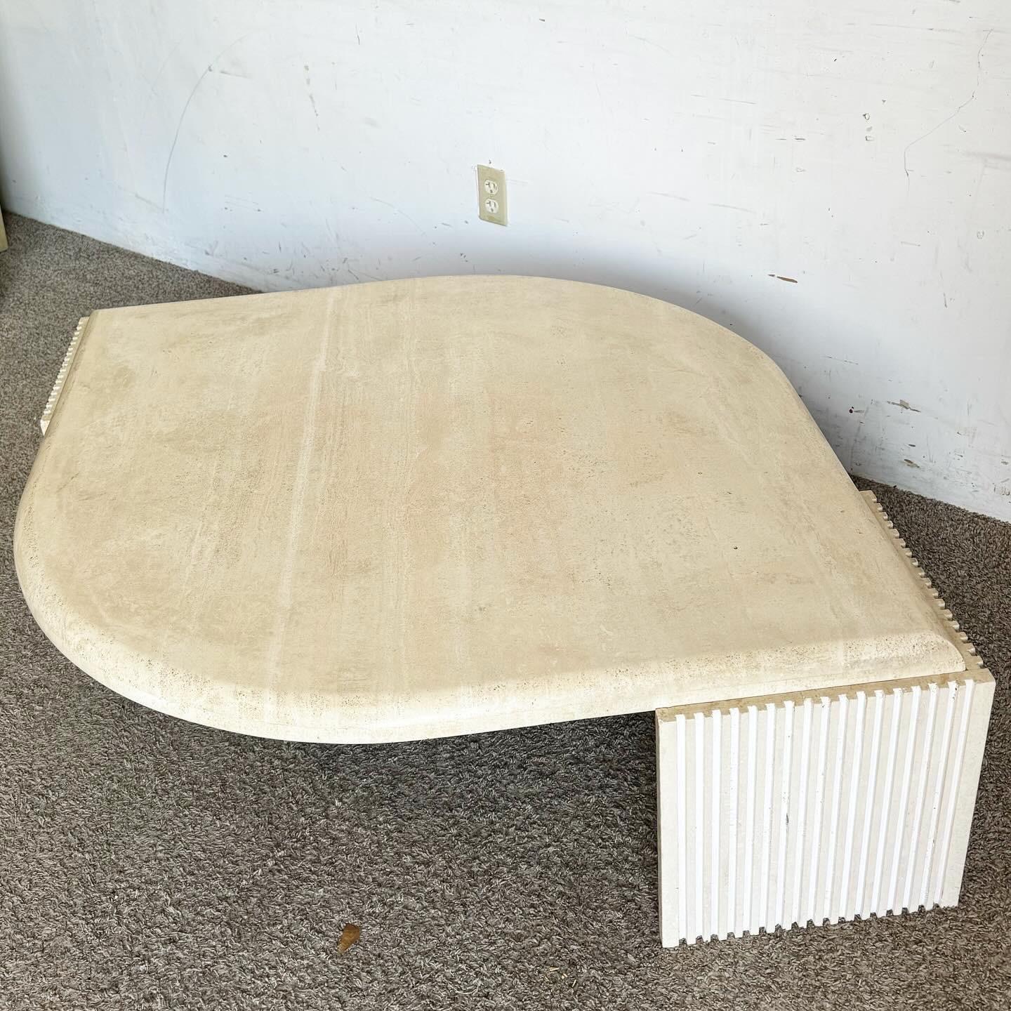 Elevate your living space with this stunning Italian Eye-Shaped Travertine Coffee Table. Crafted from luxurious travertine, it features a unique eye-shaped design that adds modern elegance. The sculpted base and smooth surface showcase the stone's
