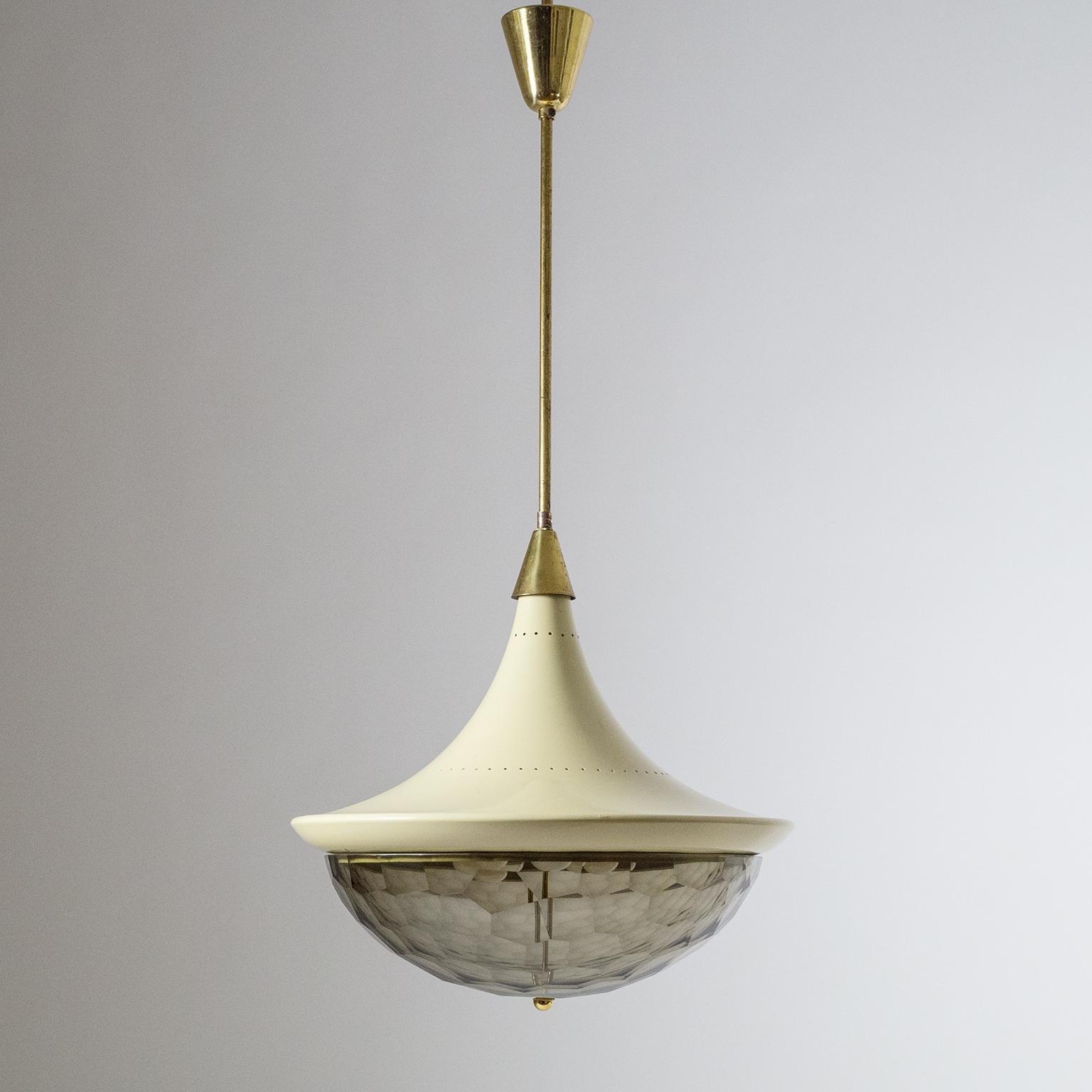 Very unique Italian midcentury chandelier, circa 1960. A large pagoda-shaped body with a multi-faceted smoked glass diffuser. Very nice original condition with patina on the brass and light wear to the original lacquer and glass. Three brass and