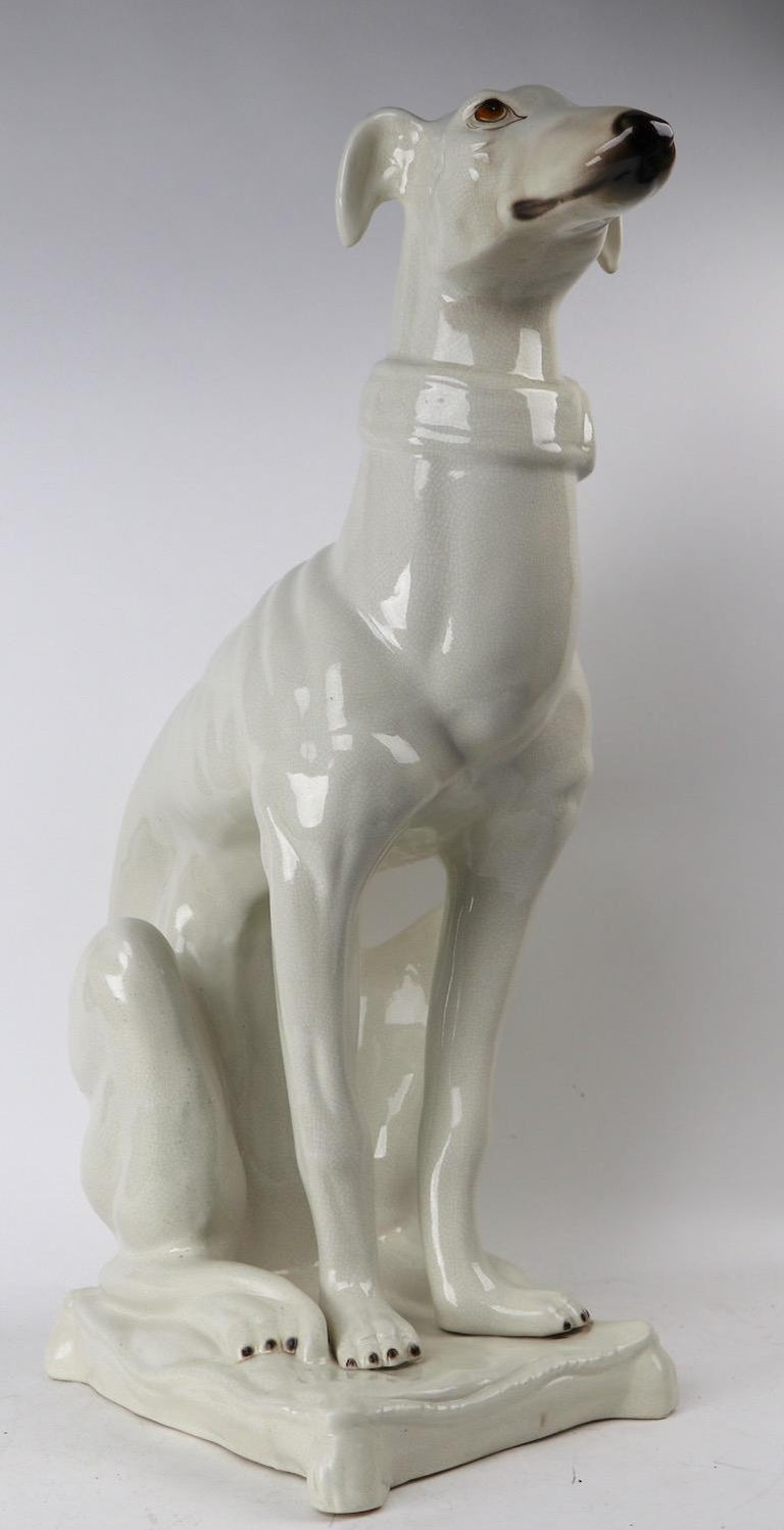 white ceramic greyhound statue