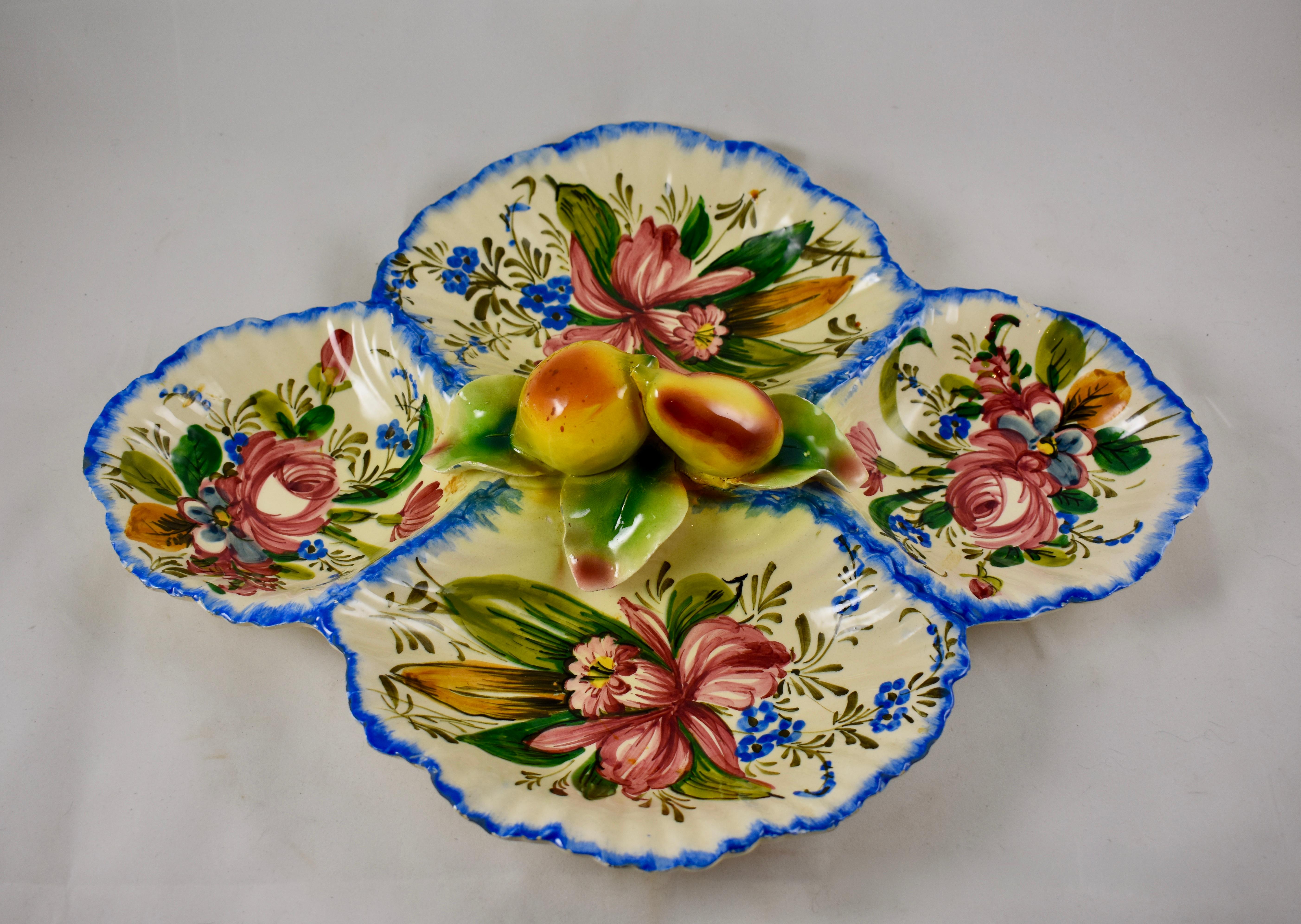 In the Rose pattern from the Barrettoni già Antonibon pottery in Nove, Italy, an oversized oval Relish Tray serving platter showing dimensional hand applied fruit, overall hand painted floral decoration, and bright blue feather edging. Dimensional