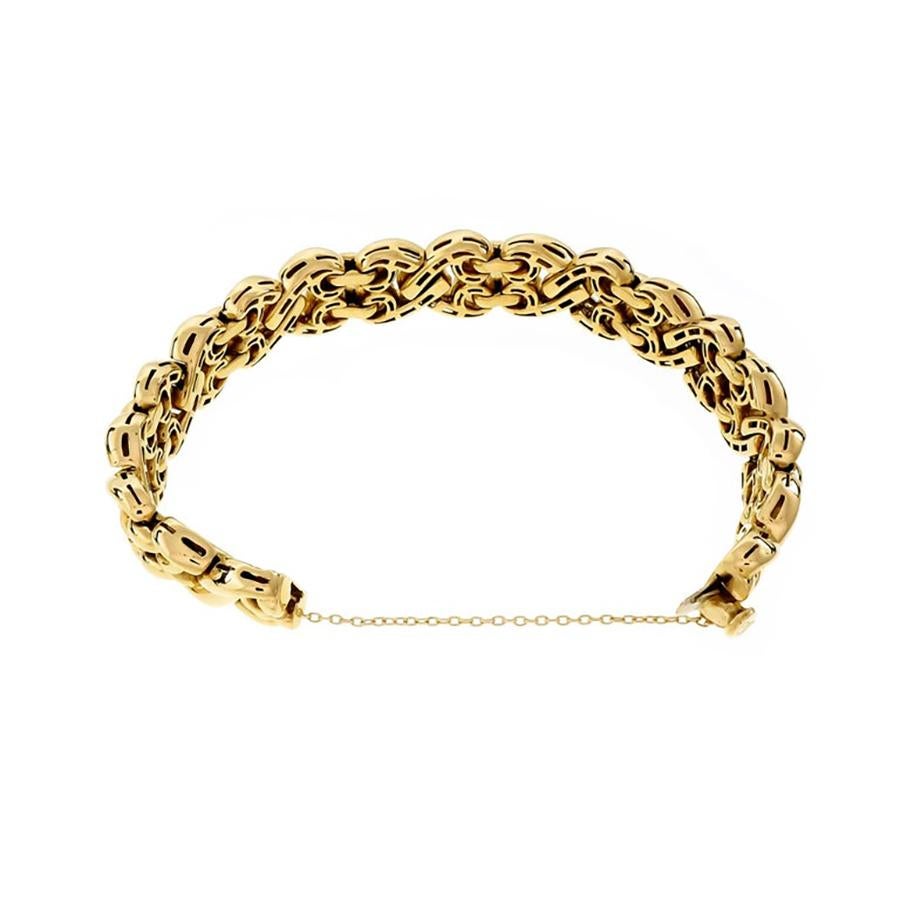 Experience the epitome of 1970's elegance with our Italian fancy gold 14mm wide link bracelet, a true masterpiece of Italian craftsmanship. Built in hidden catch plus safety chain. The wide links offer a bold statement, while the rich, lustrous 18k
