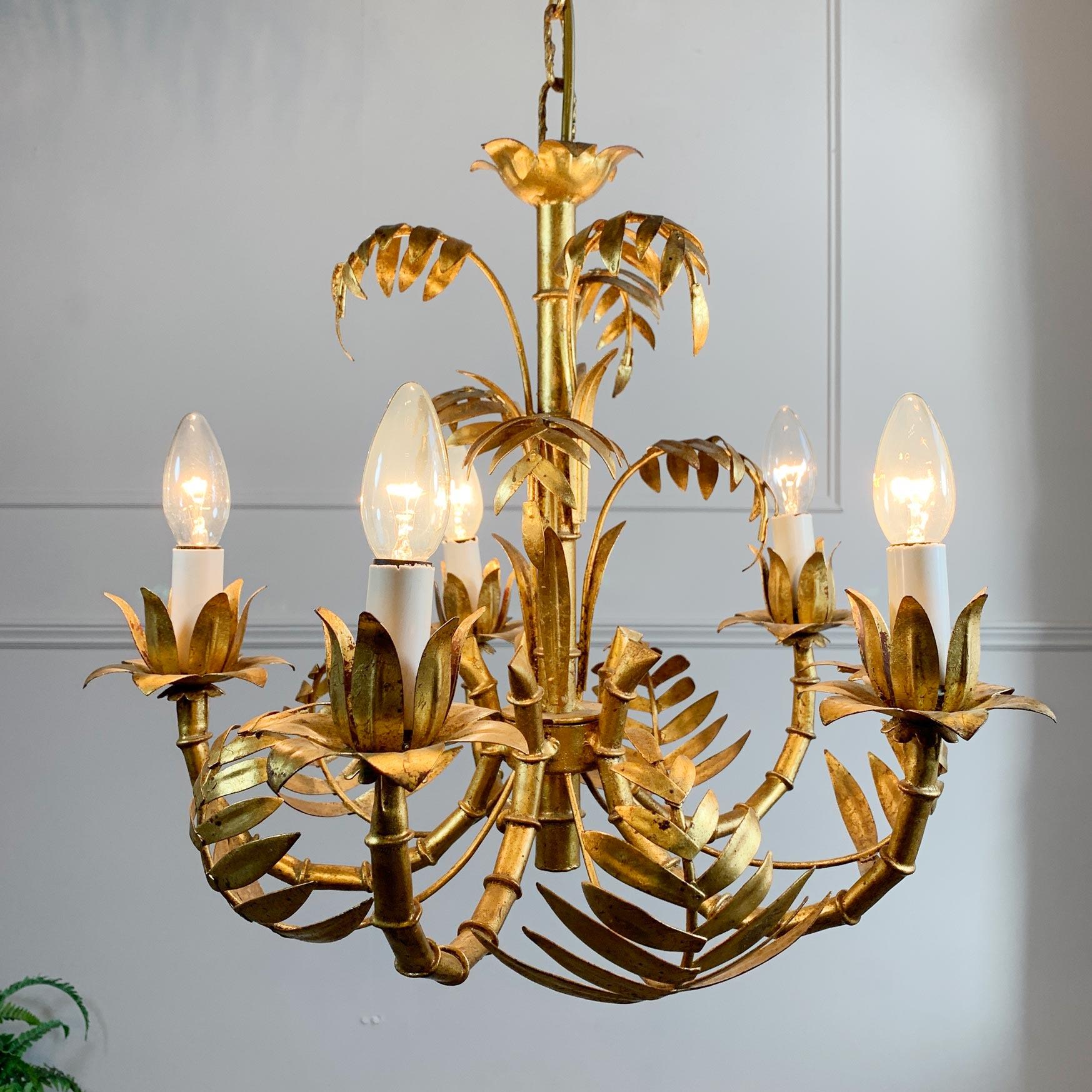 An incredible 5 arm gilt faux bamboo chandelier, Italian dating to the 1970's. The arms designed as bamboo, surrounded by leaves and foliage, the entire light finished in gilt leaf.

This chandelier is in stunning vintage condition.

Measures: