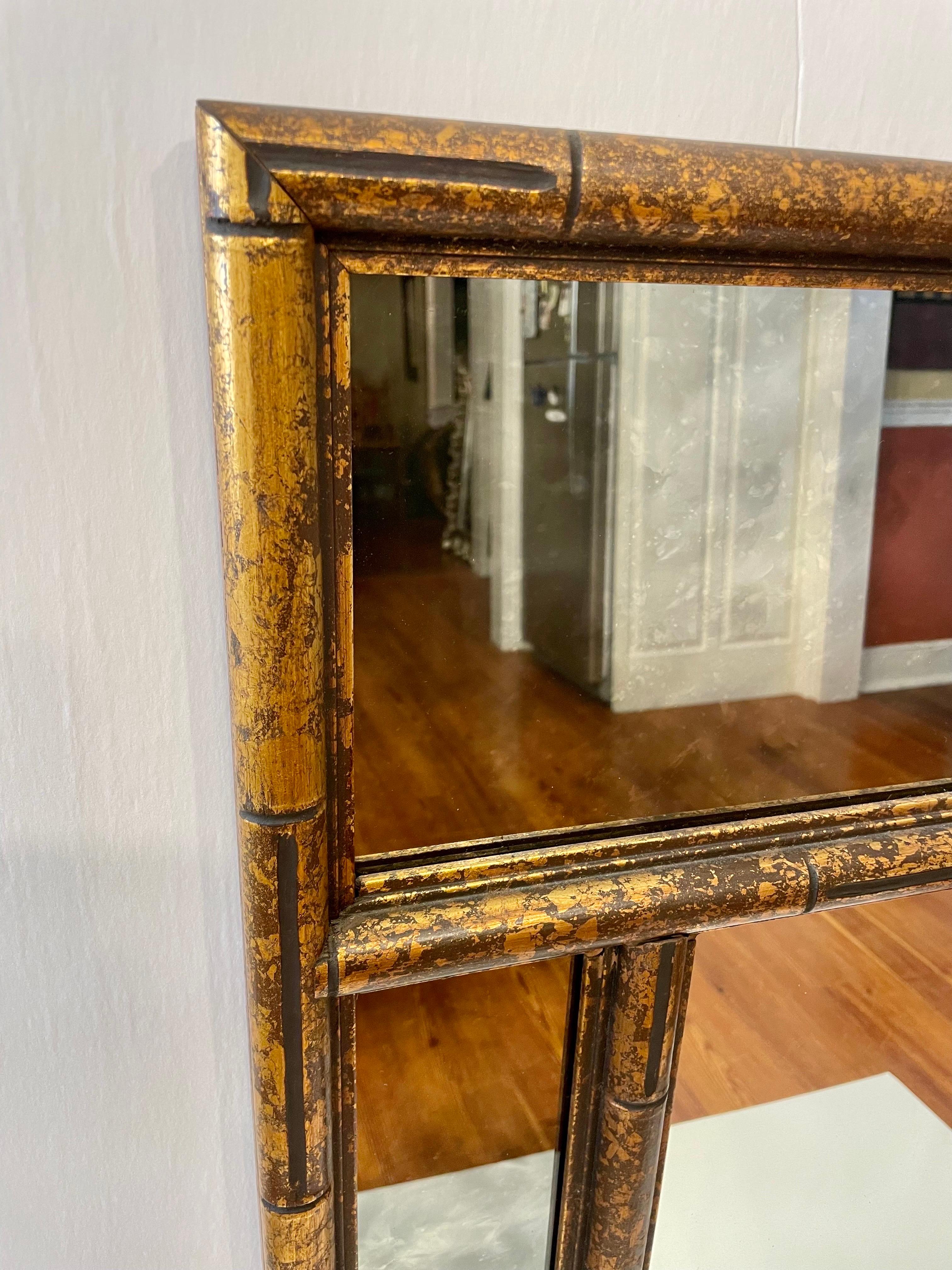 Large Faux Bamboo Mirror with smoked mirror surround, gilt tortoise finish. Center clear mirror is 36