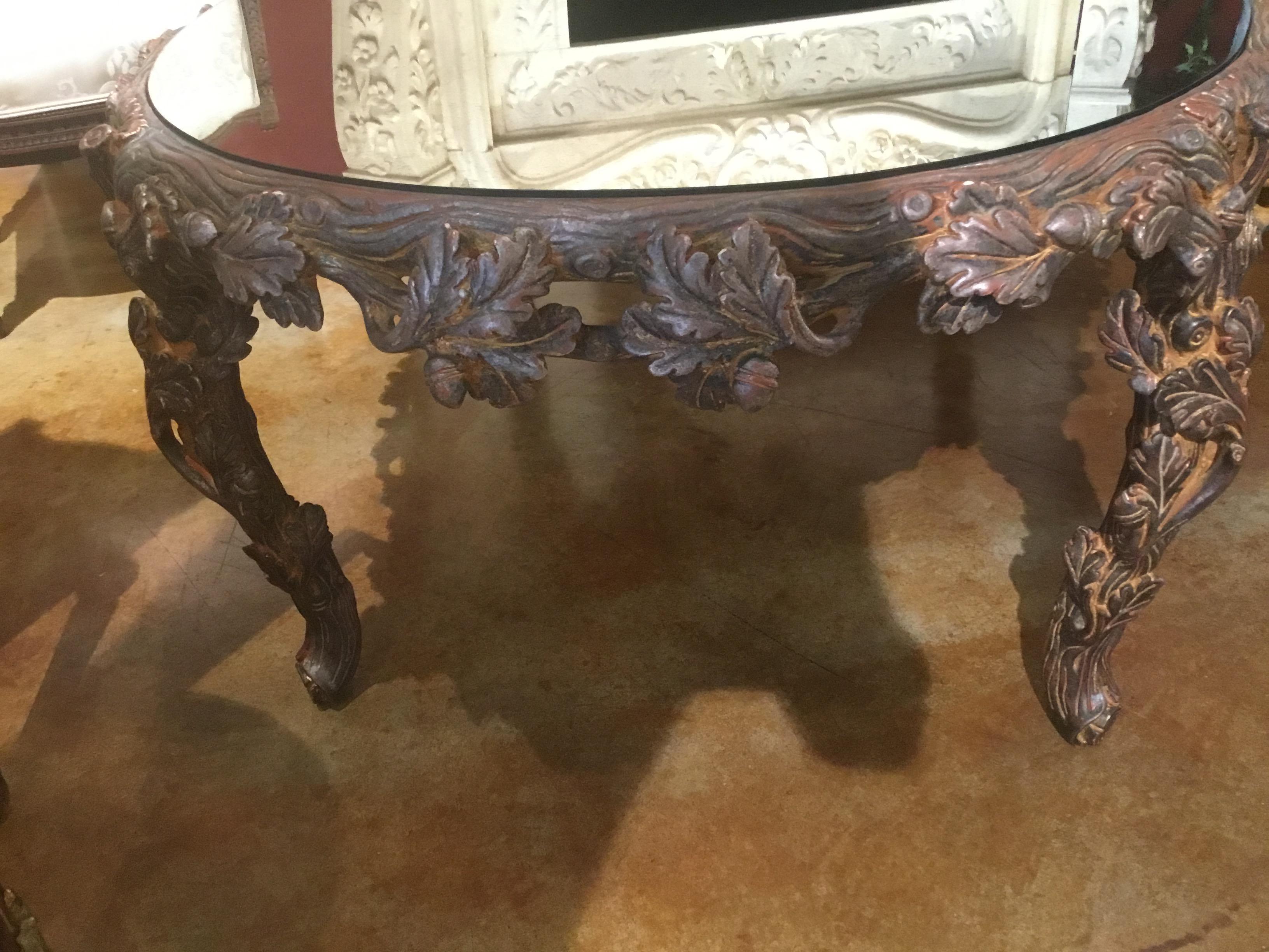 Mirror-top oblong coffee table made in metal with a faux bois design
with an oak leaf and acorn motif, 20th century. The top is a mirrored bronze with
antiqued finish.
 