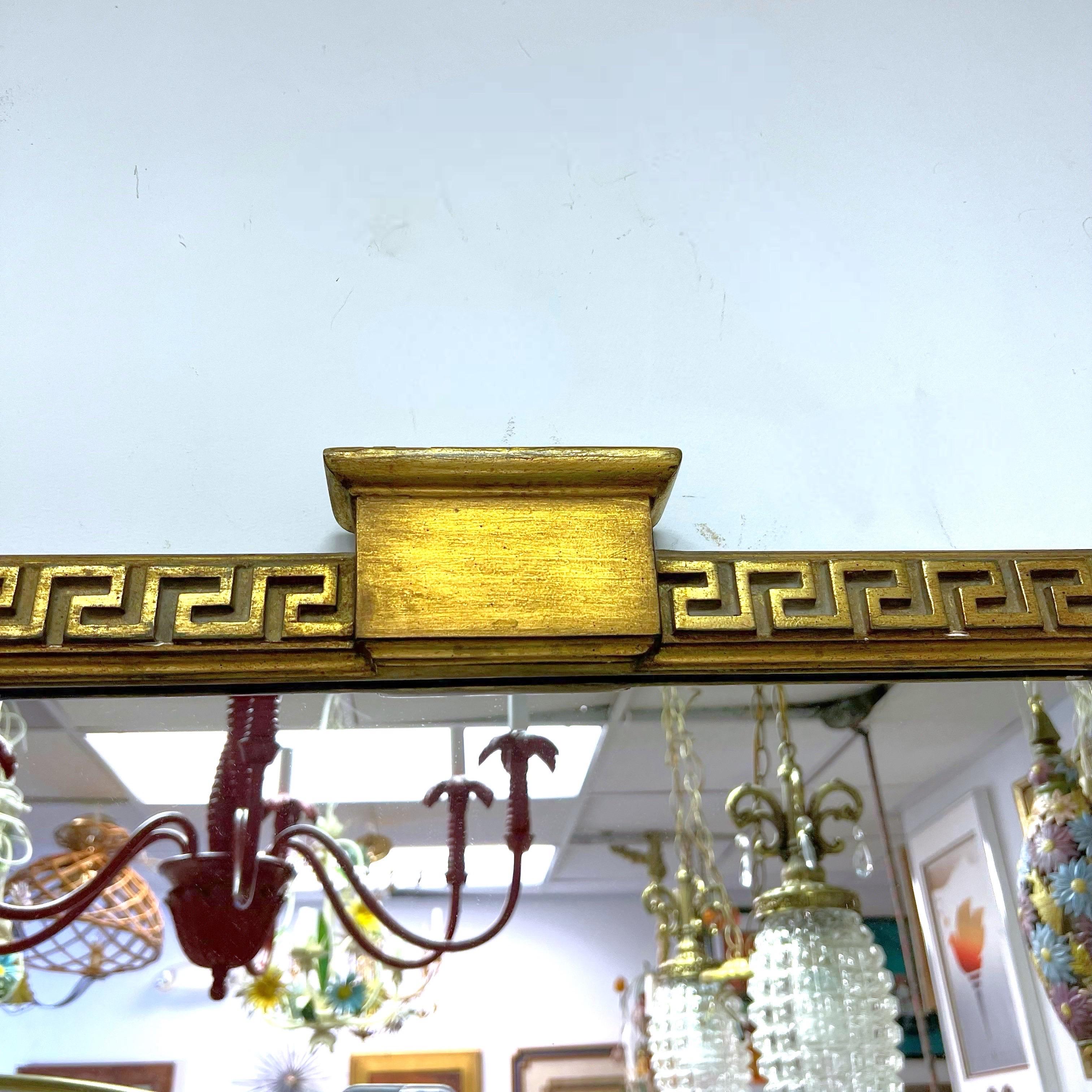 Vintage federal style wall mirror with a Greek key boarder terminating in corner rosettes, and bears the Borghese maker's label en verso, circa 1930.