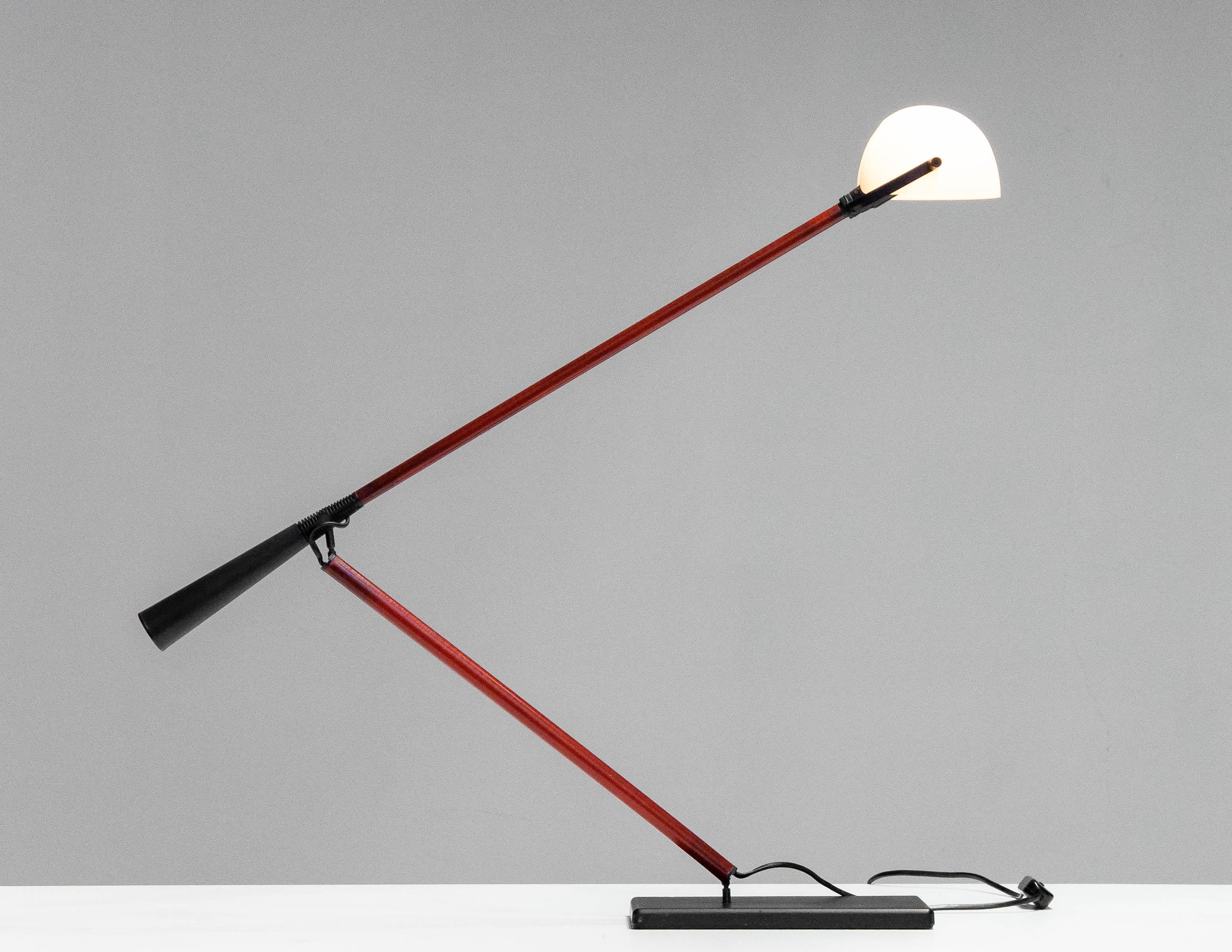 Italian desk lamp / table lamp Model: 613 designed by Paolo Rizzatto for Arteluce in the '70s. The table lamp has a rectangular metal base with a mounted twisting arm made of fiberglass. Fiberglass arm with counterweight 
Inside the adjustable