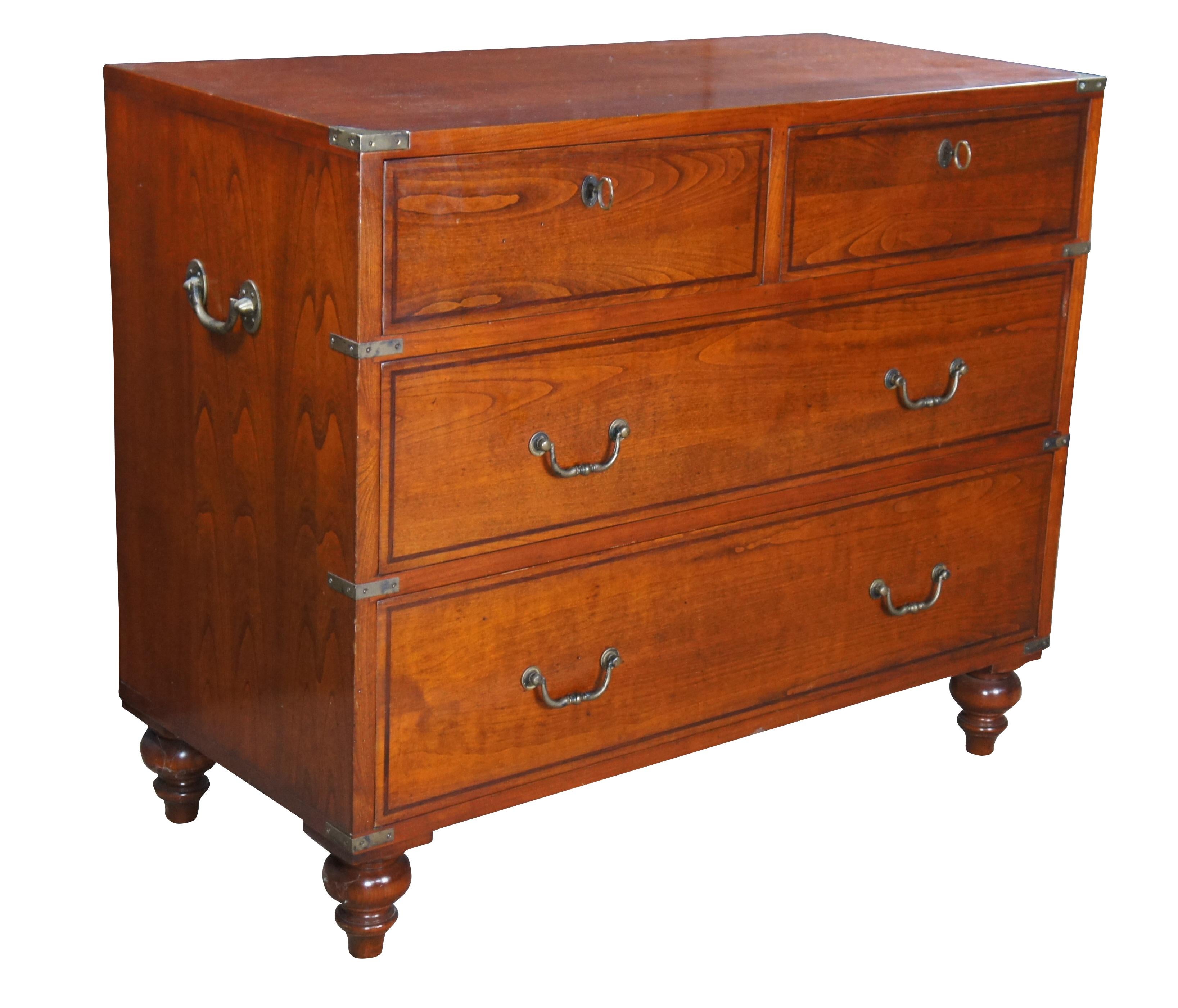 Vintage Italian Fiorini Campaign style chest or dresser. Made of solid cherry featuring four drawers, brass hardware and turned feet.  Two upper drawers lock.  Made in Italy.

Dimensions:
35