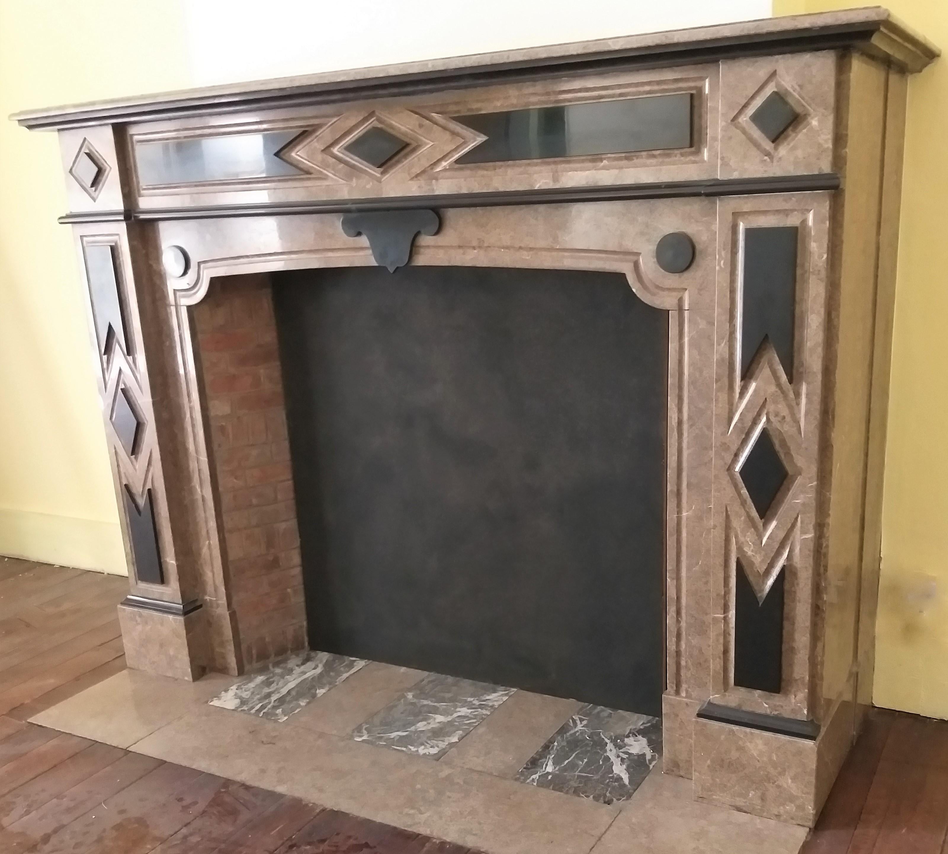 A late 19th century, polished fireplace from Italy, made out of an Italian, warm-brown marble: Napoléon Grande Mélange.
The blackest black Belgian marble: Noir de Mazy, is fancy decorating the frieze, jambs, foyer-frame and the moulded shelf.
The