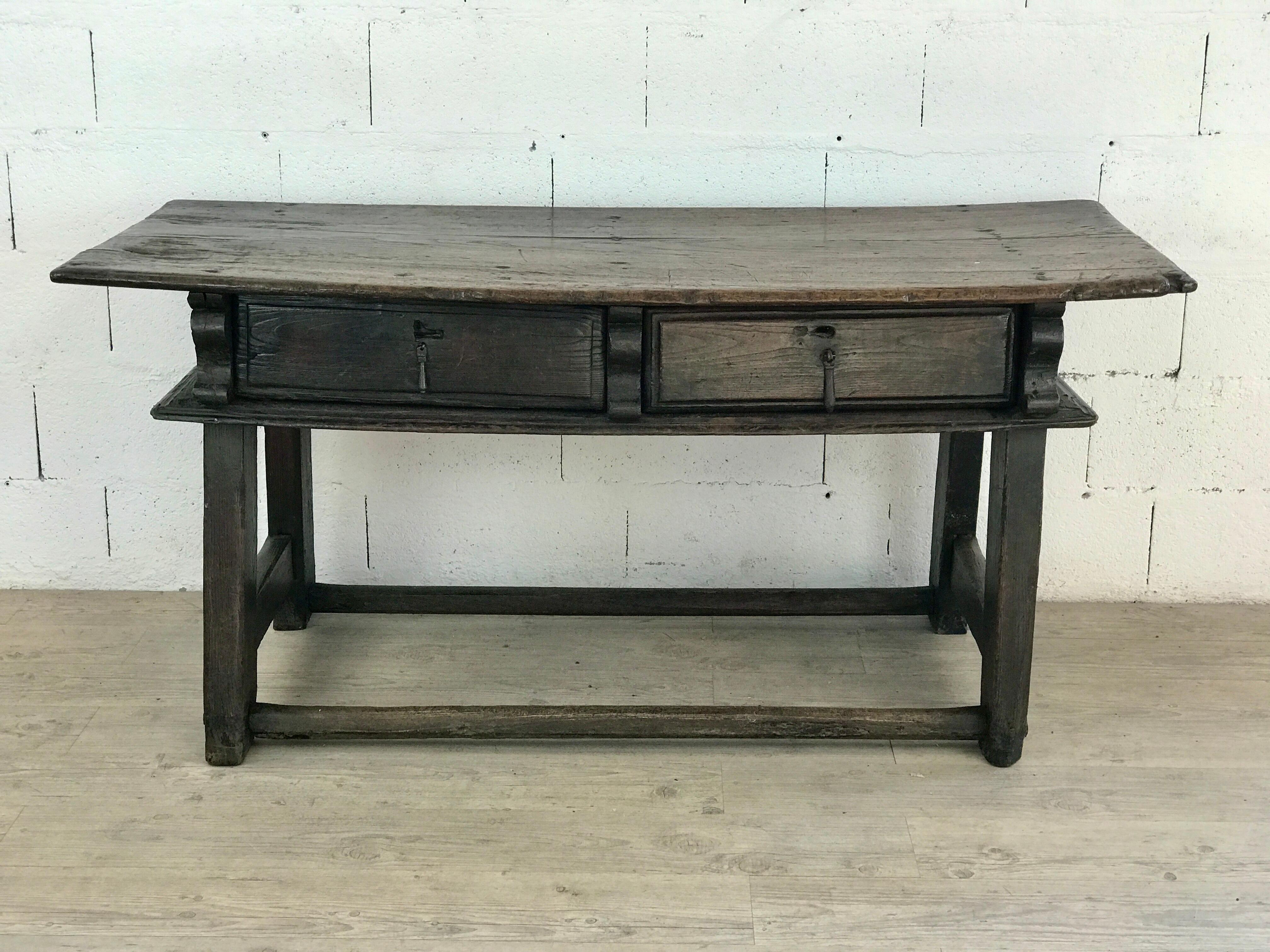 This magnificent Italian writing desk, dating from the late 17th century, is a striking example of Renaissance-inspired craftsmanship. Made of richly patinated, waxed wood, it features a deep, warm hue that enhances its timeless character. The