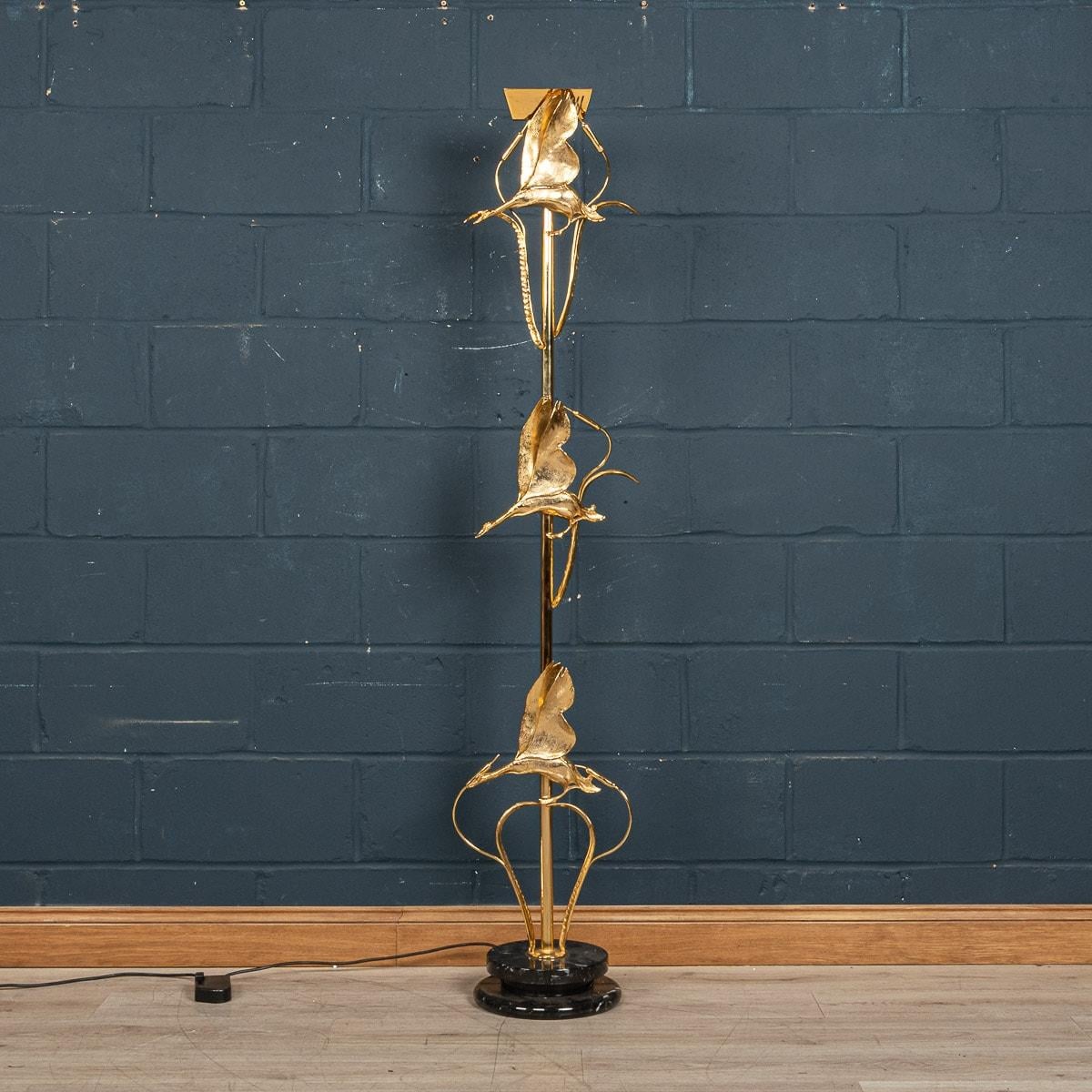 A exceptional late 1970s / early 1980s Hollywood Regency floor lamp by Lanciotto Galeotti for L' Originale, in Florence, Italy. An extremely high quality gilded bronze and brass sculpture that is mounted on a round black marble base. The stem of the