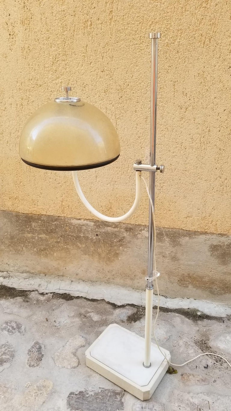 Floor lamp by Luci has a combination of chrome, metal, and marble base. The shade is made of fiberglass which gives a beautiful warm light. Base dimensions are 18 x 16 inches.

  