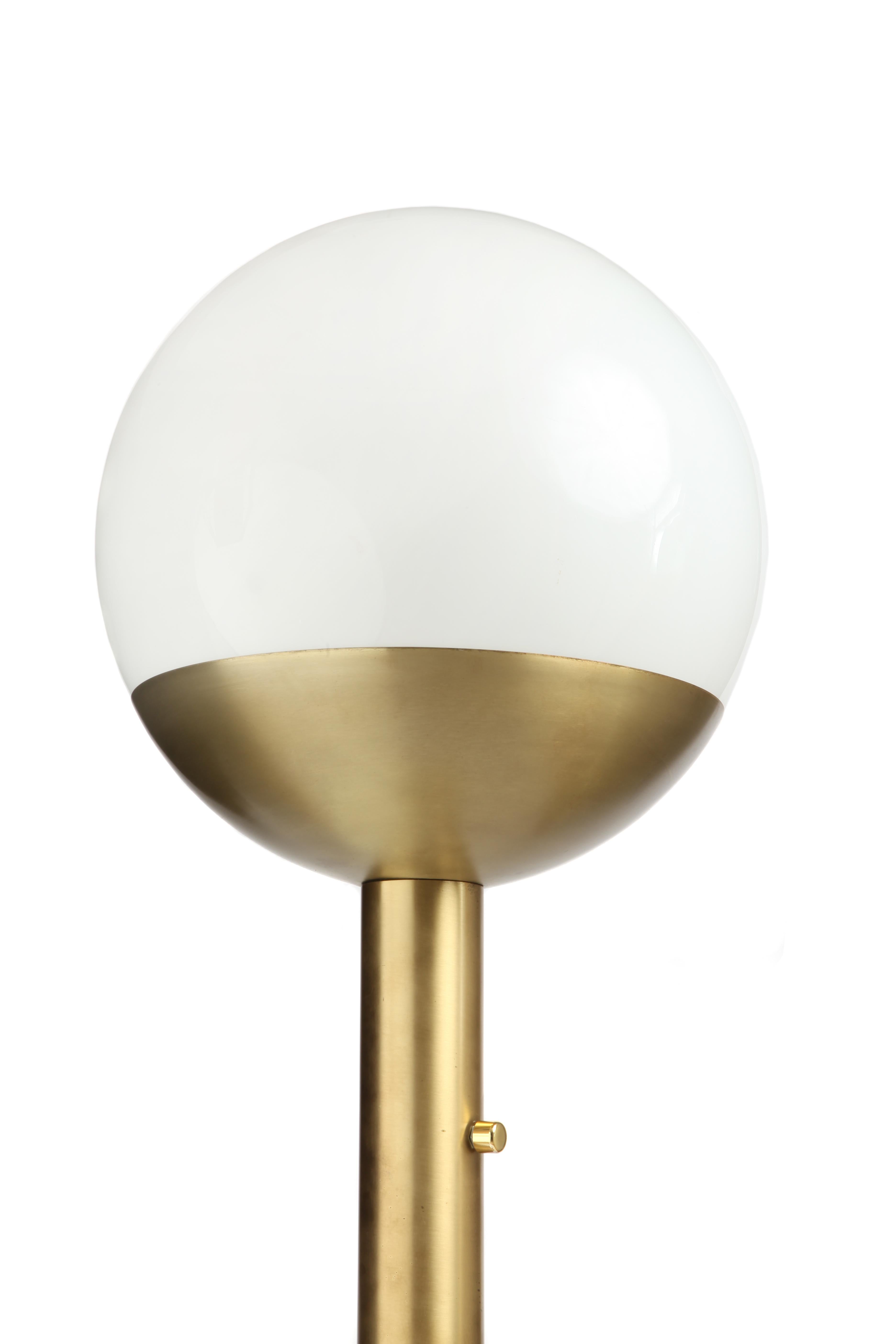 Vintage Italian floor lamp from the 1970s. Brass base and stand with opal glass orb.

P428 lamp in brass and opalin glass by Pia Guidetti Crippa for Luci from the 60s. Structure in golden brass with bronze patina and lamp shade in white opaline