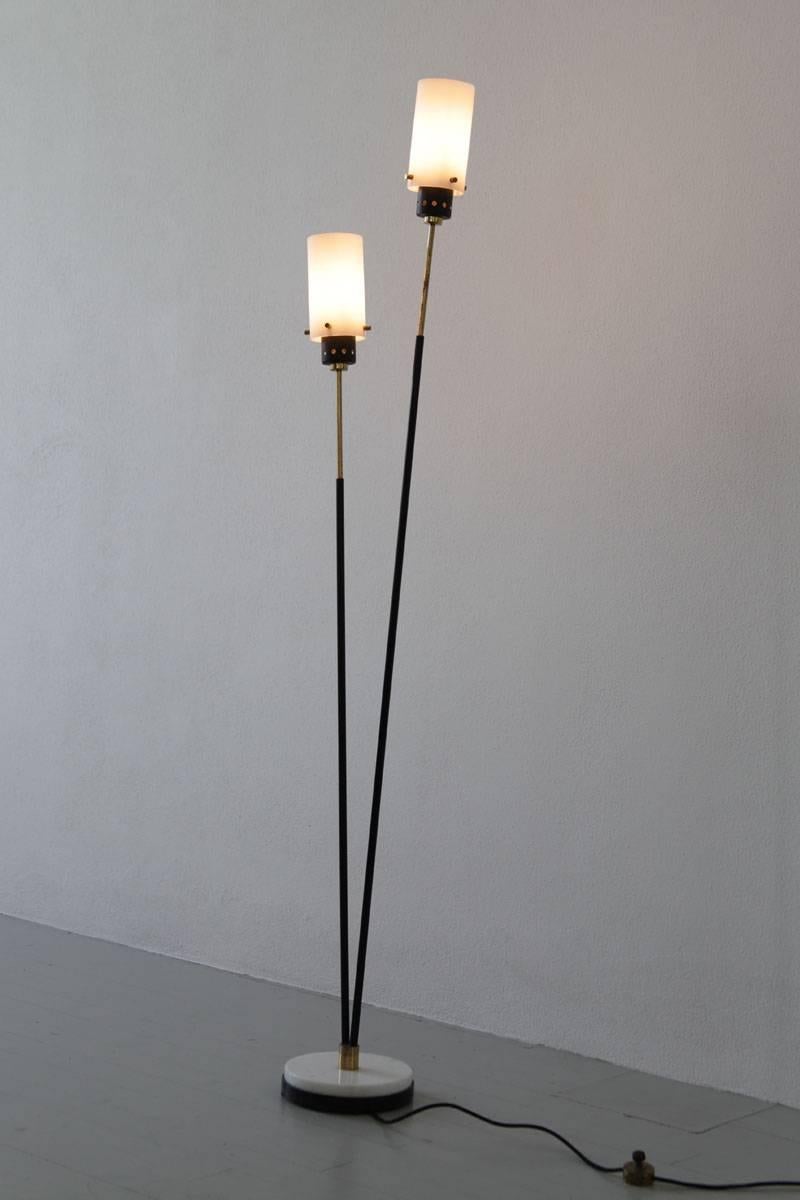 Italian floor lamp, designed and manufactured by Stilnovo in Italy, 1950s. This floor lamp is made of a dark body, resting on a marble base and two opaline glass shades.

   
  