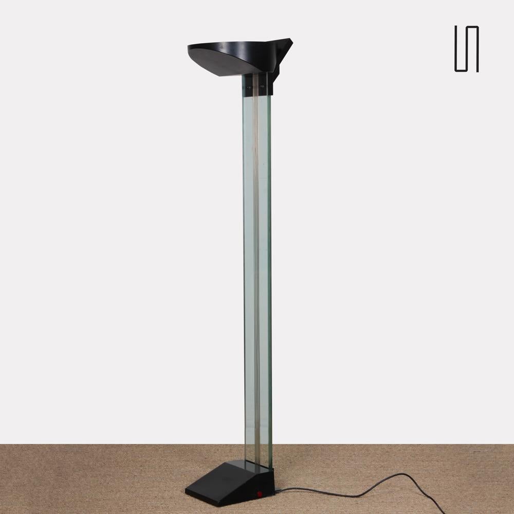 This Italian floor lamp was produced by UP in the 1980s. The upright is made of a glass slab. The shade and base are in black plastic.