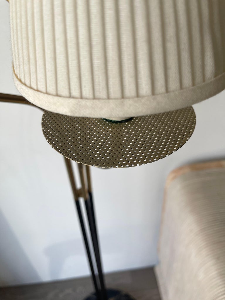 This elegant floor lamp has a marble base and brass accents. It’s a very nice Italian design.