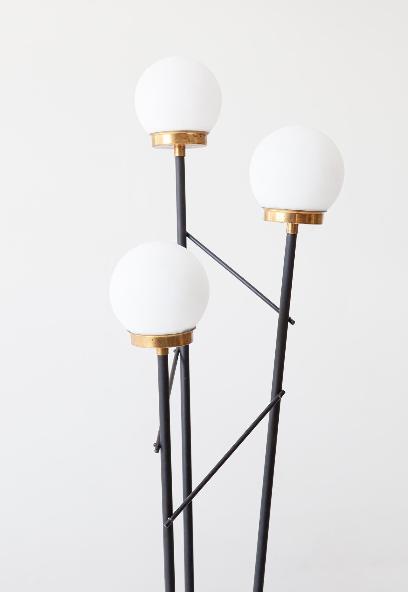 Floor lamp, black enameled steel, opaline glass, brass and marble base, Italy, 1950s

The marble base is heavy but small in size, because it is a little higher than normal, from there rise three black enamelled steel tubes at the ends of which are