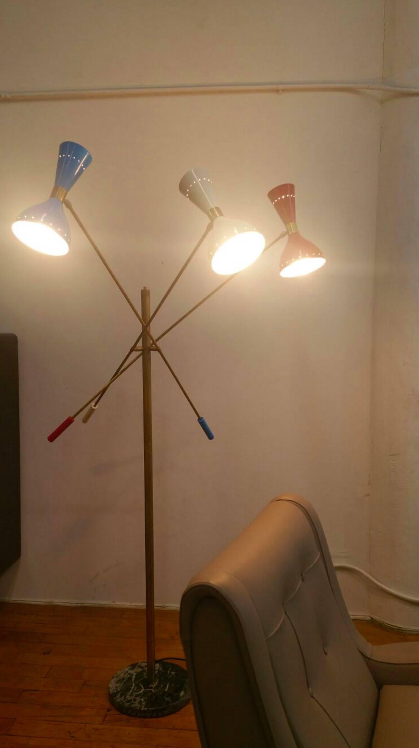 Italian Stilnovo style floor lamp with three arms movable and marble base, Triennale style, brass stem and colored cones white, blue and red. Rewired and ready to use, late 20th century. This floor lamp sizing is approximate as the arms move and you