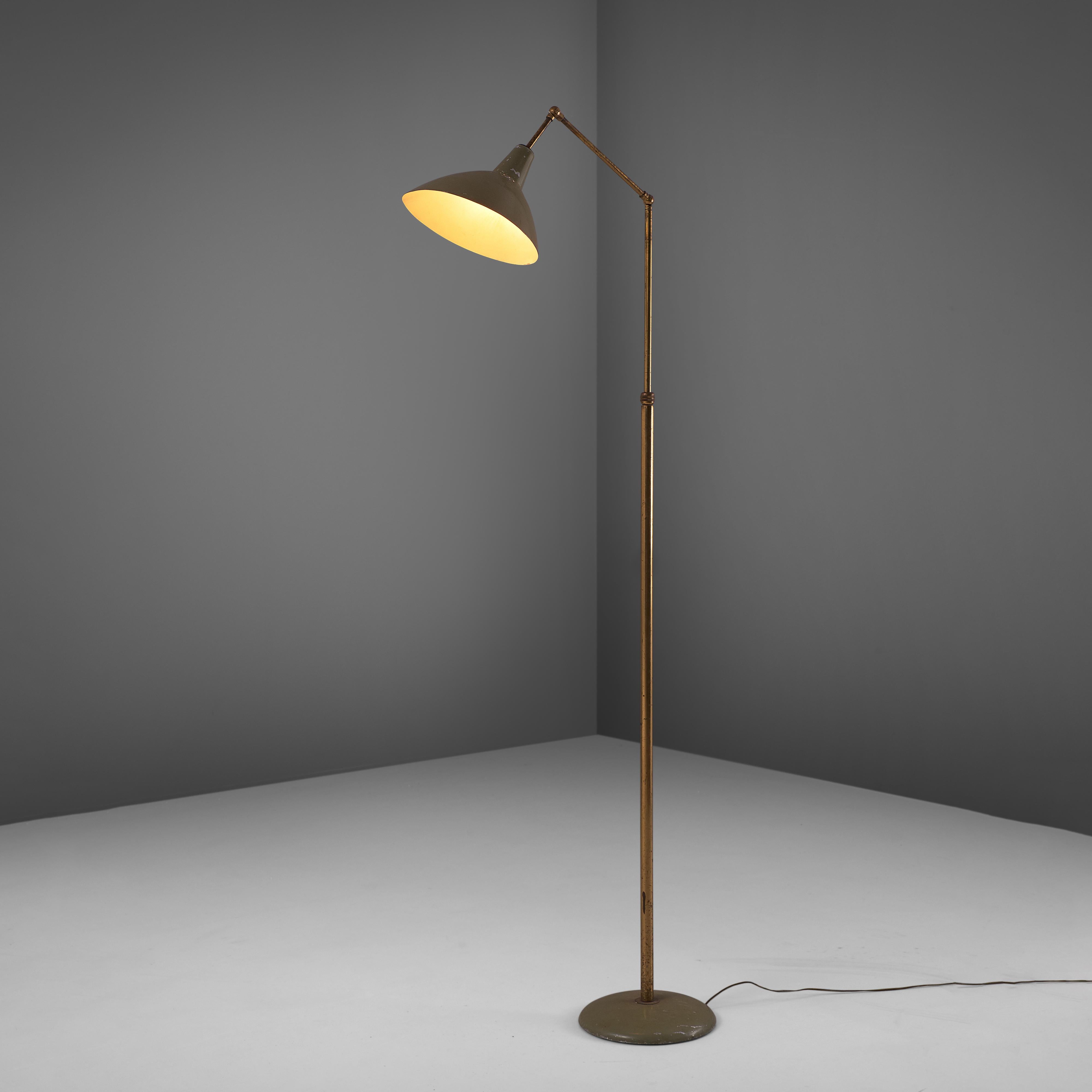 Floor lamp, metal and brass, Italy, 1950s.

This Italian floor lamp combines great aestethics with functional aspects. A round green lacquered metal base. The slim stern in brass is nicely patinated and has two pivot points to position the shade in
