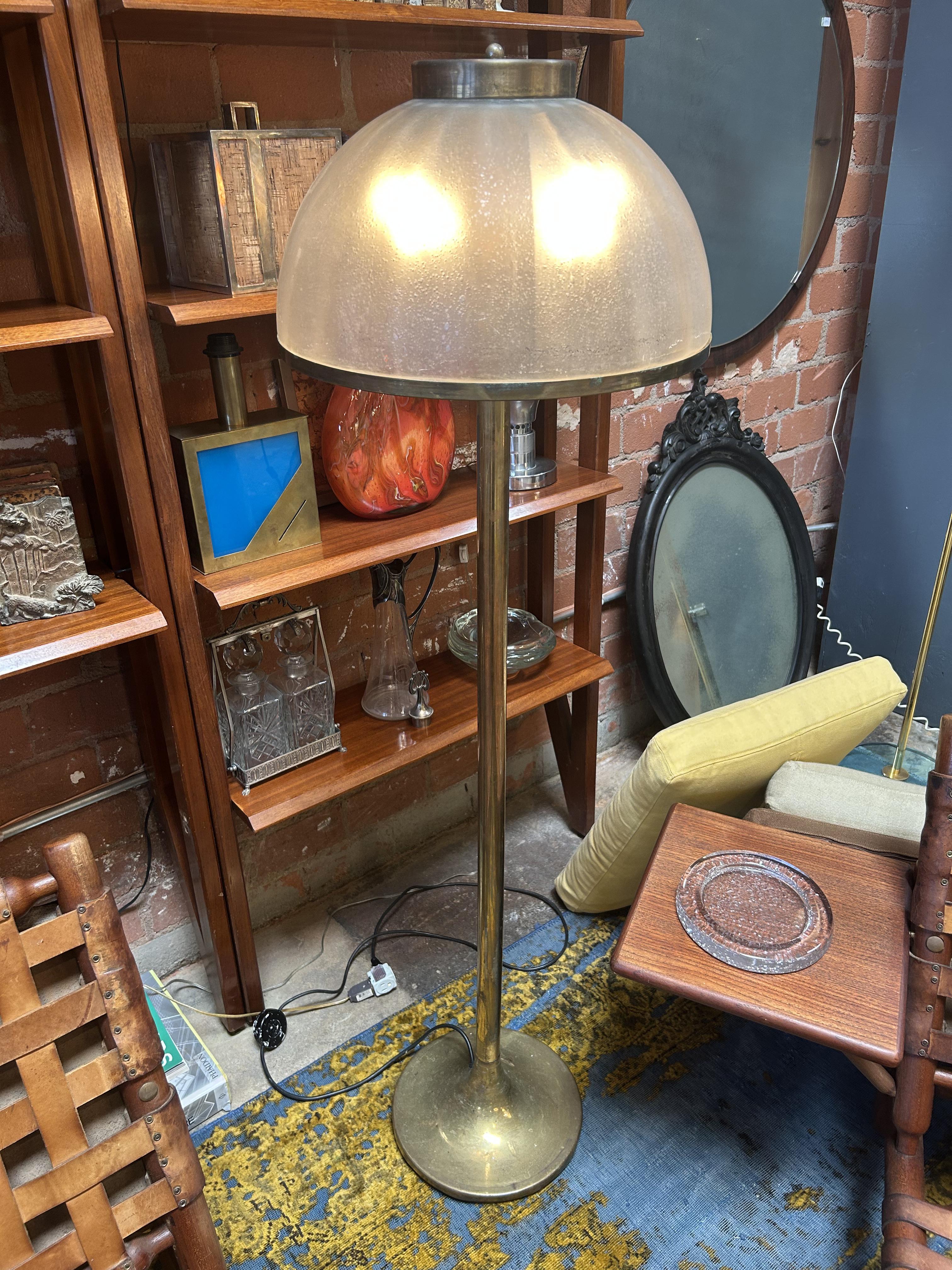 A sculptural and elegant Italian floor lamp from the 1970s, defined by its clean vertical lines and refined material palette. The lamp features a domed shade in thick, textured Murano-style glass with a softly bubbled surface that diffuses light