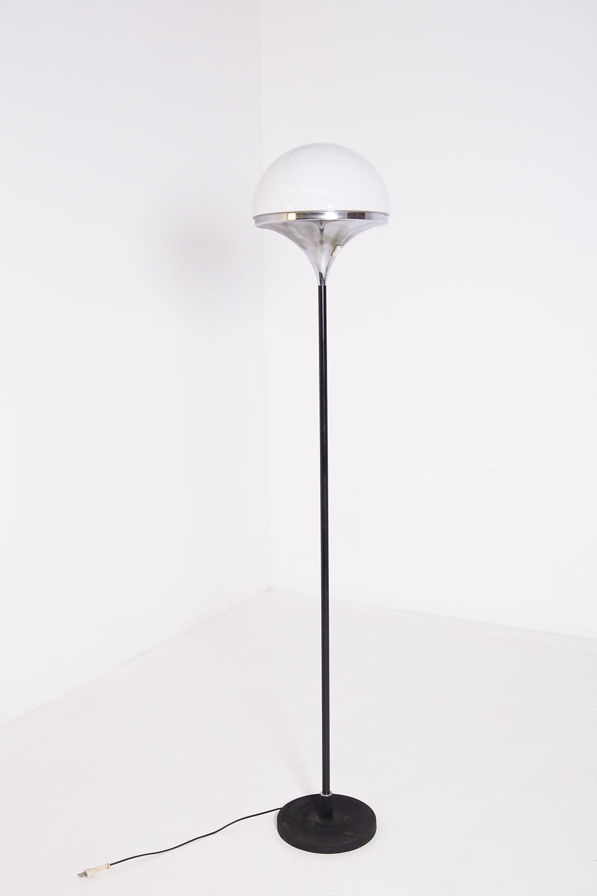 Floor lamp manufactured by Stilnovo at the end of the 50s and beginning of the 60s. 
The terr lamp is made with an iron or cast iron base painted black with a painted steel stem.
The ceiling lamp that contains its light and semi-spherical opaline