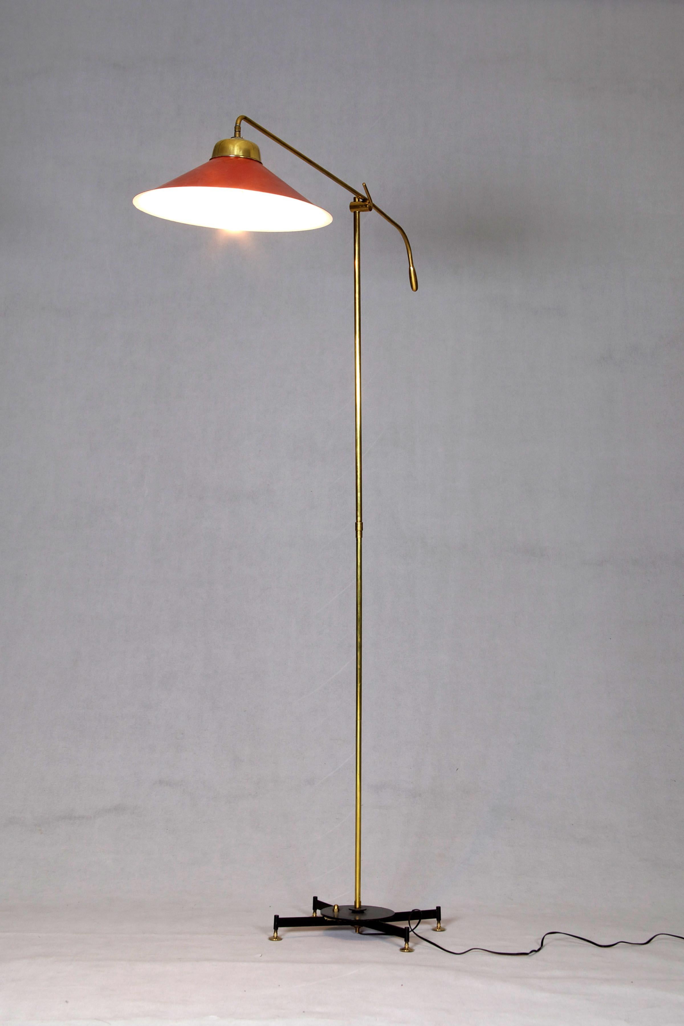 Floor lamp with adjustable brass arm and lacquered shade. Italy, 1950s.