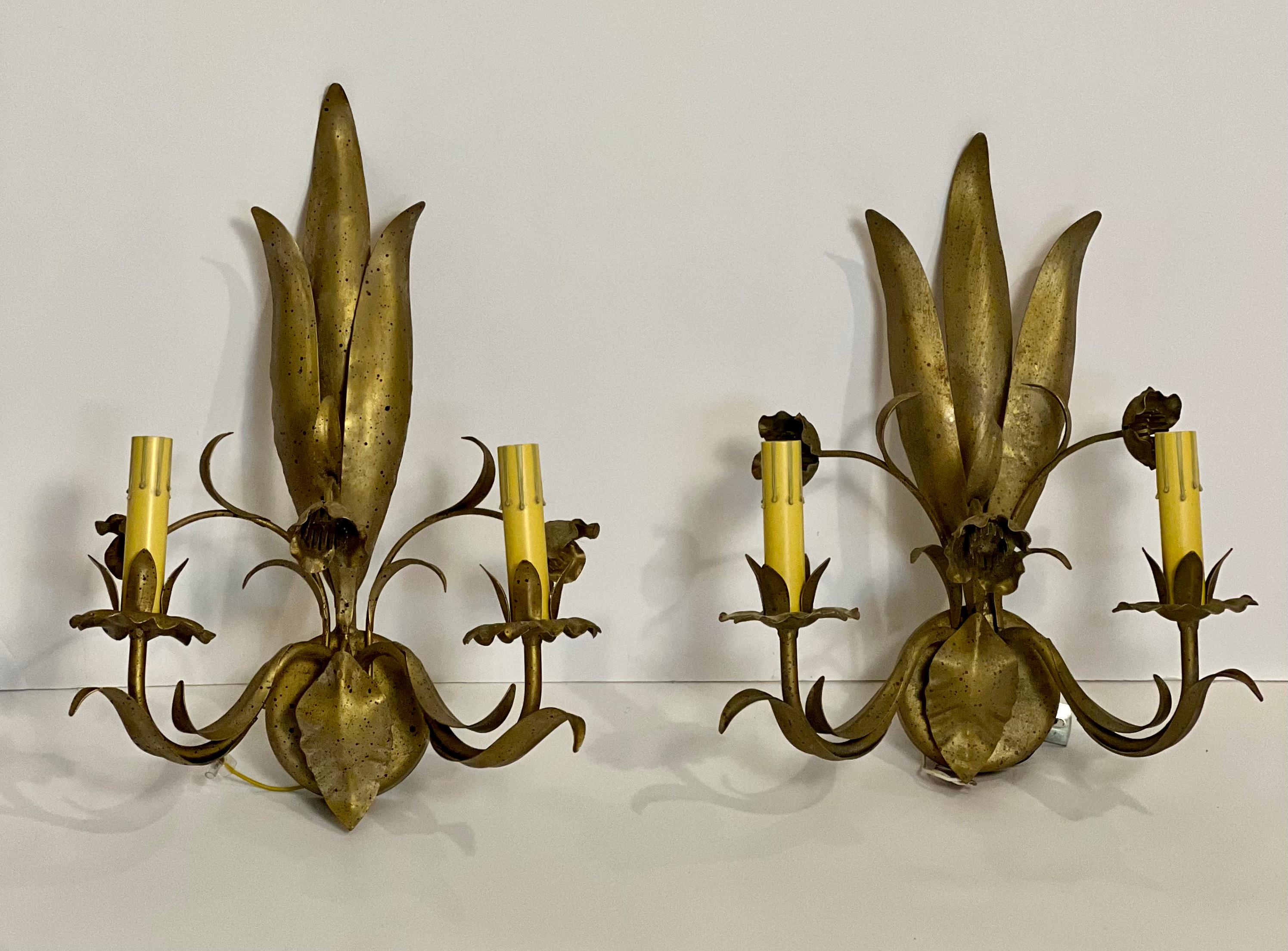 Elegant Italian sconces with beautiful free-form floral and leaf design. 

Unique pair features a matte gold with black speckled finish having a lightly aged look. Each sconce is a little different due to individual craftsmanship. In good condition