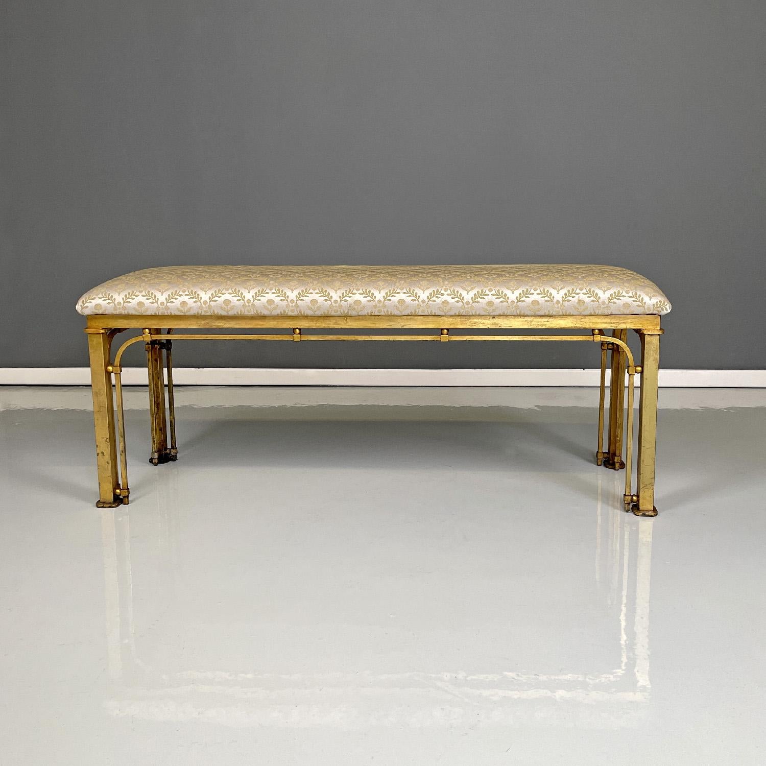 Italian floral fabric footrest or bench with golden metal structure, 1980s
Rectangular bench or footstool. The seat is padded and covered in beige fabric with golden floral decorations. The structure has a square section and is in golden metal with