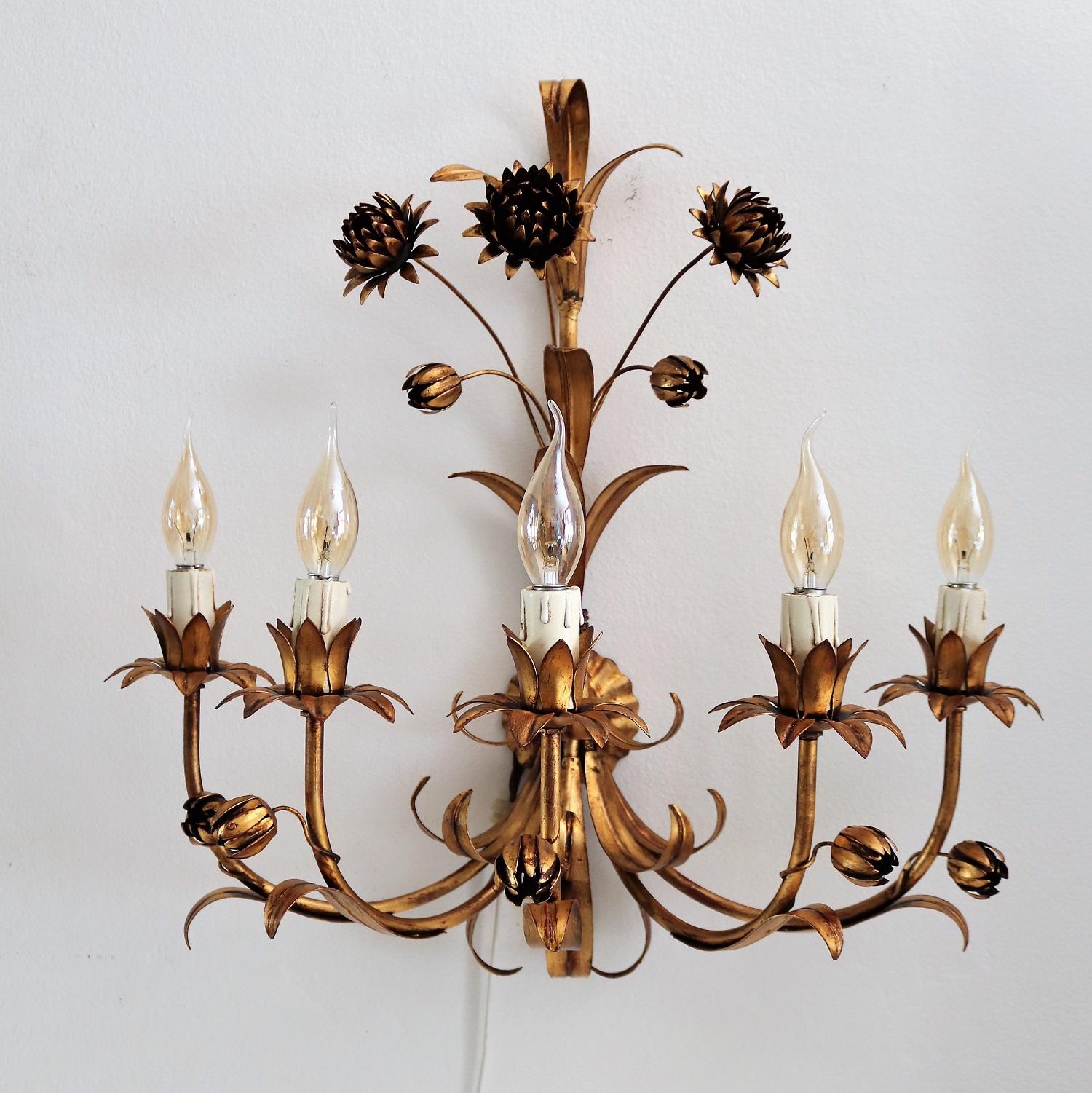 Beautiful pair of gilt metal wall sconces with 5 lights each showing flowers, leafs and buds.
The sconces have been produced during the 1970s in Italy.
Both appliques have been cleaned and checked and are in excellent vintage and working